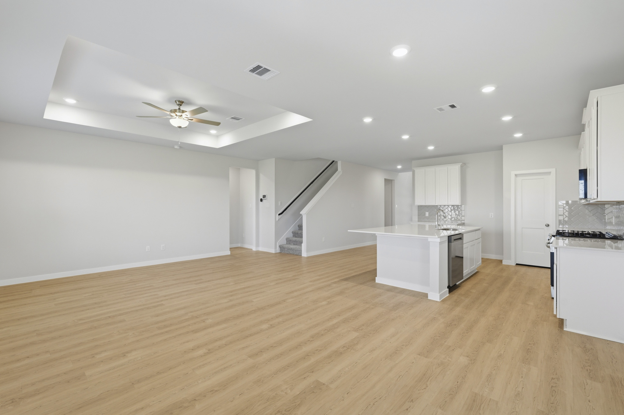 A large kitchen with white cabinets.