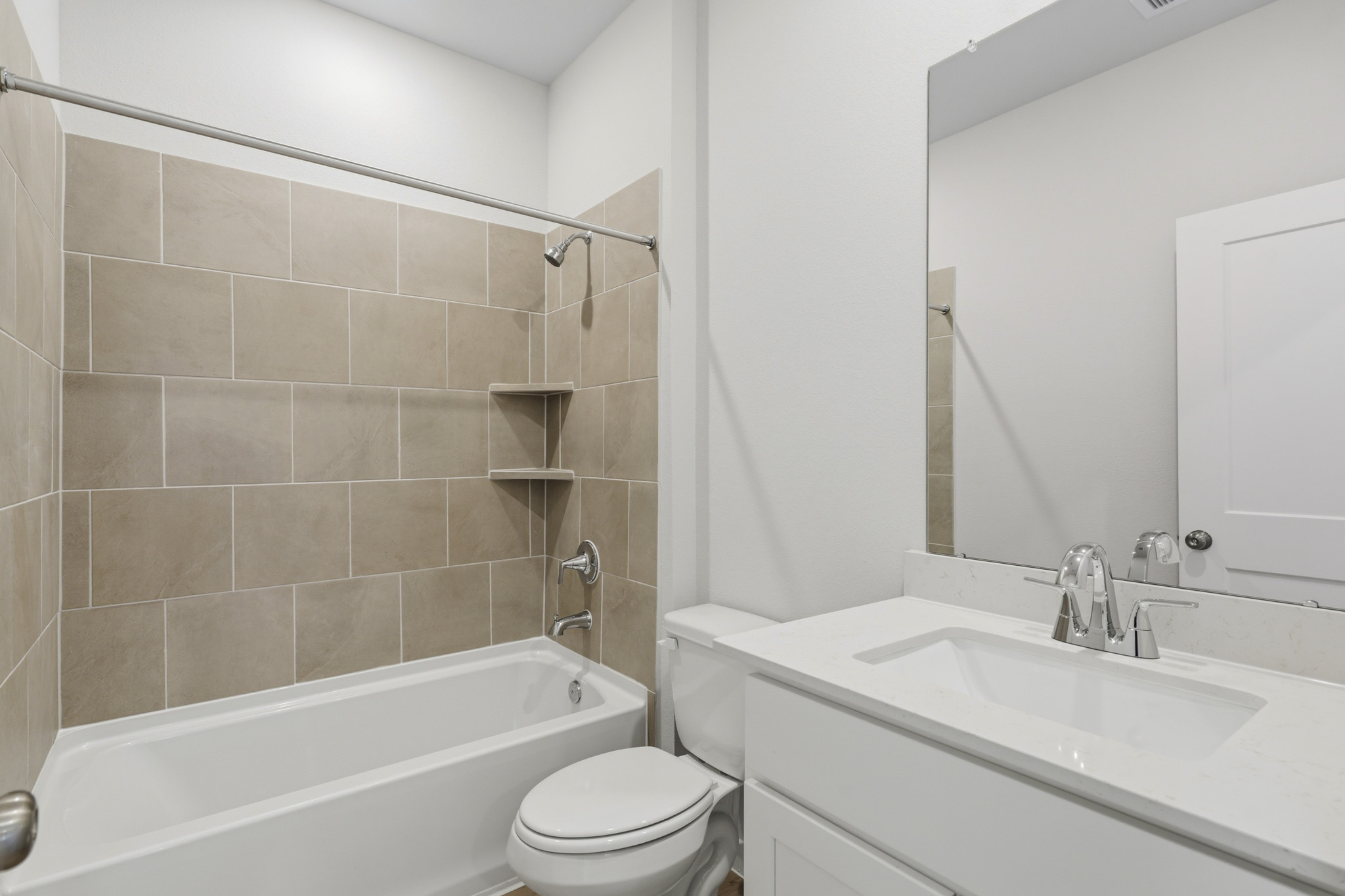 A bathroom with a tub sink and toilet.
