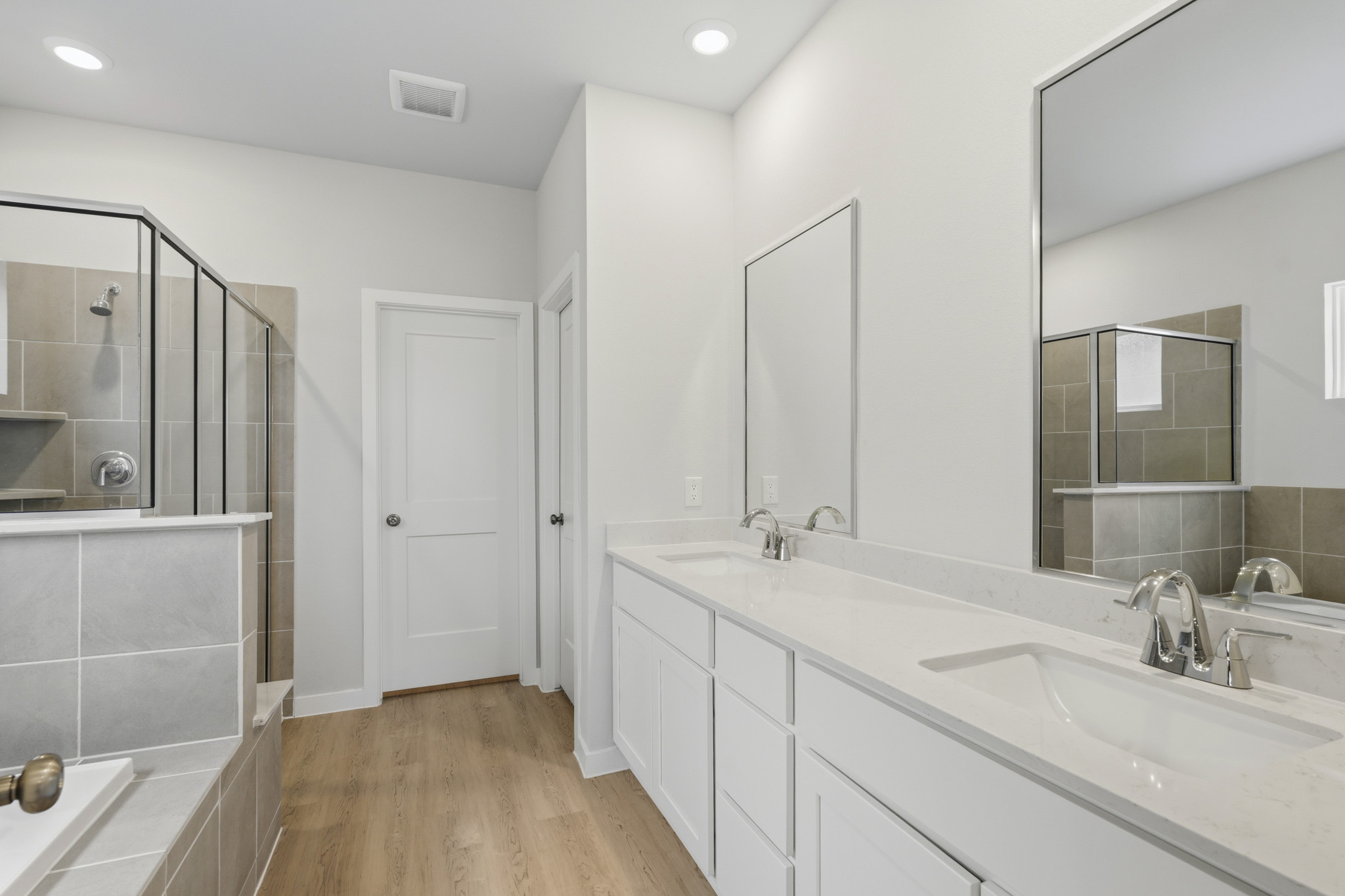 A bathroom with white cabinets.