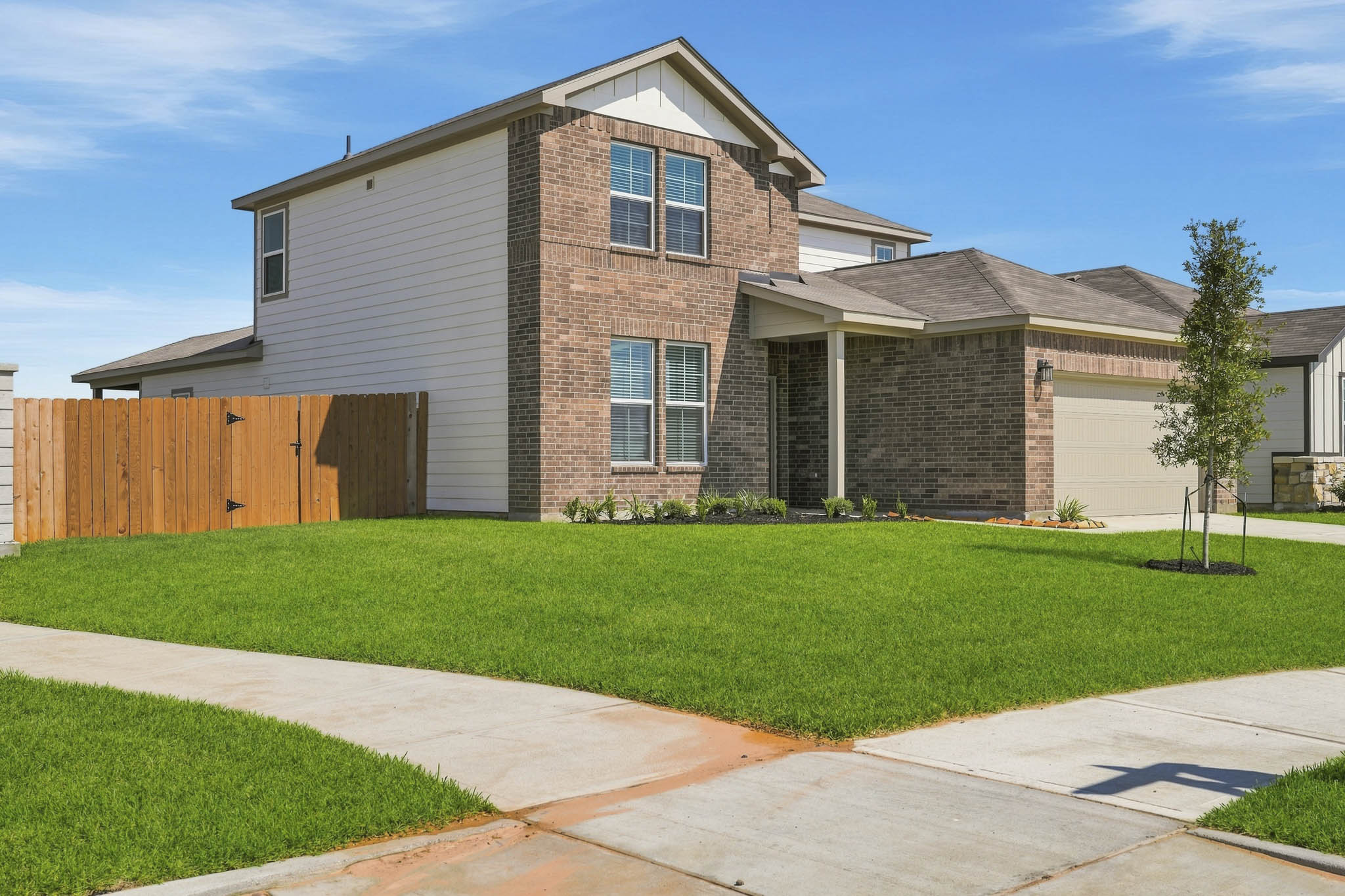A house with a fence and grass.
