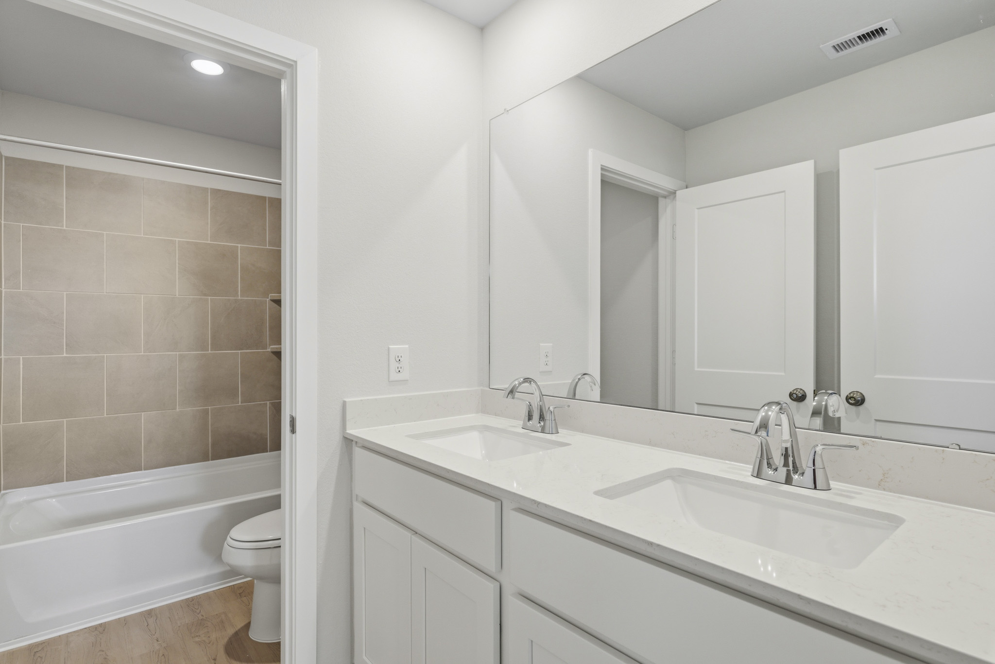 A bathroom with a tub sink and toilet.