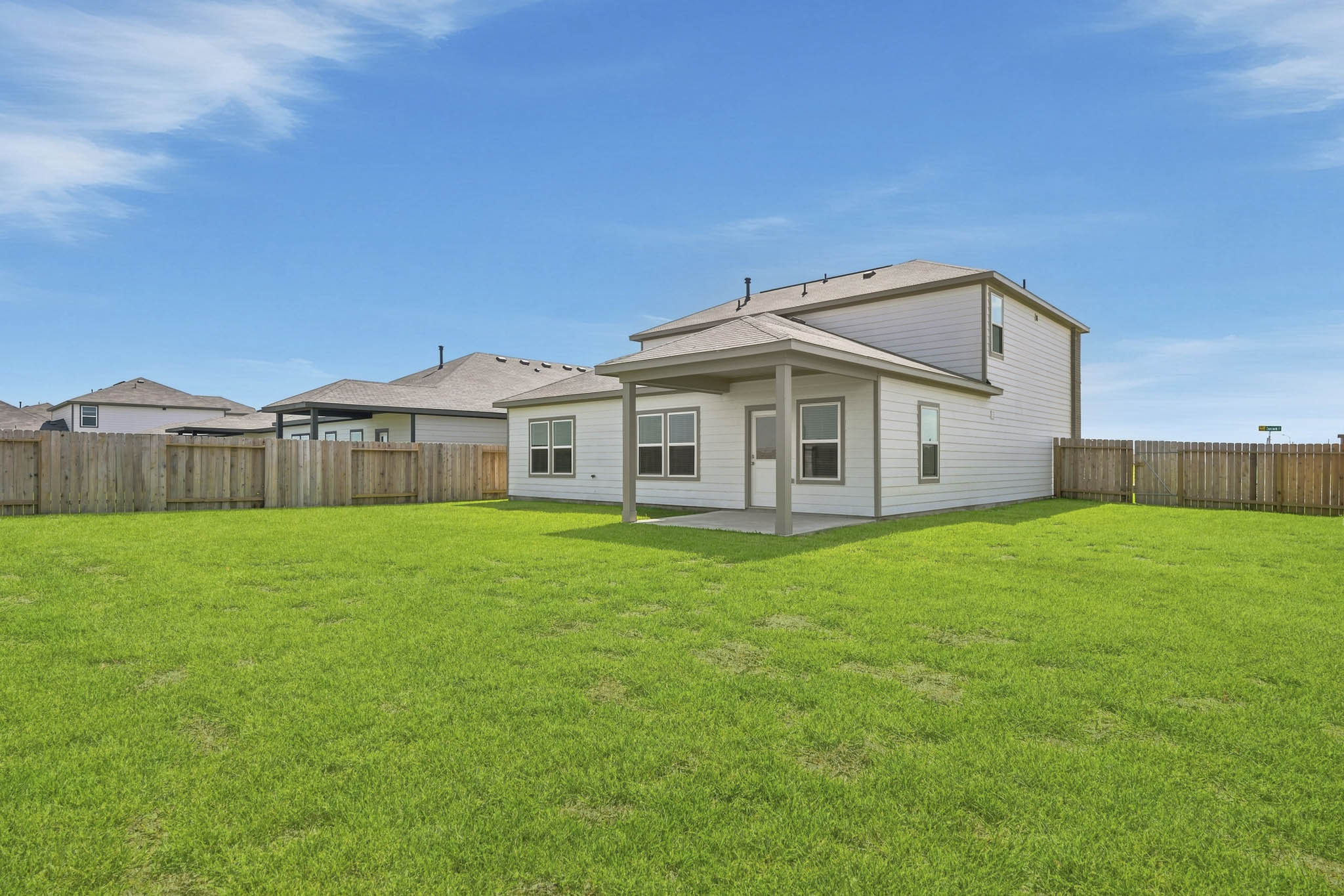 A house with a fence and grass.