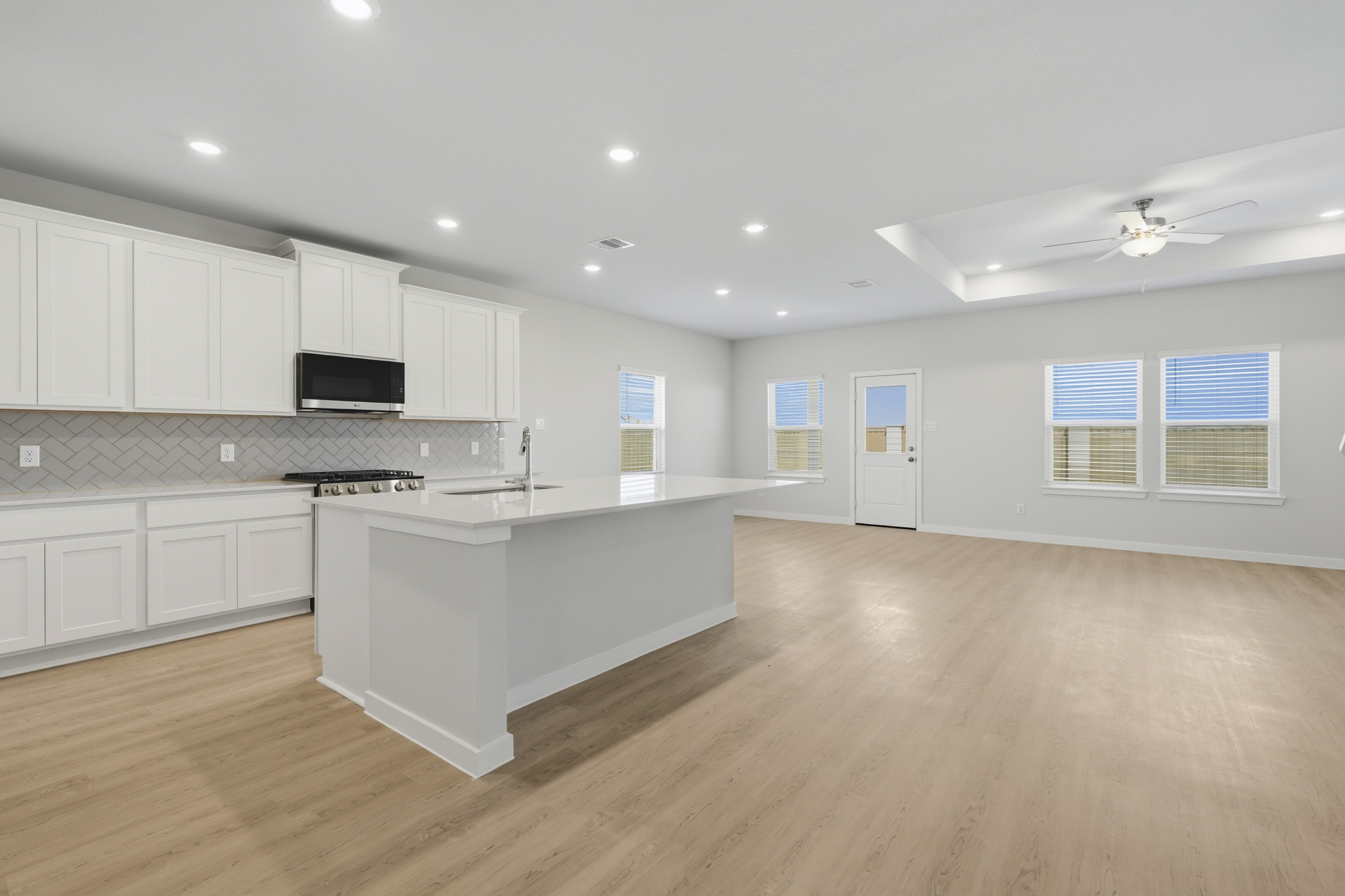 A kitchen with white cabinets.