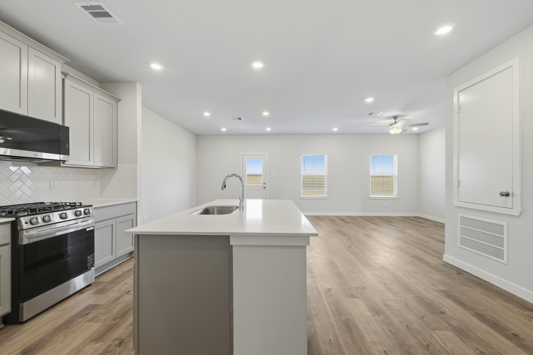 A kitchen with white cabinets.