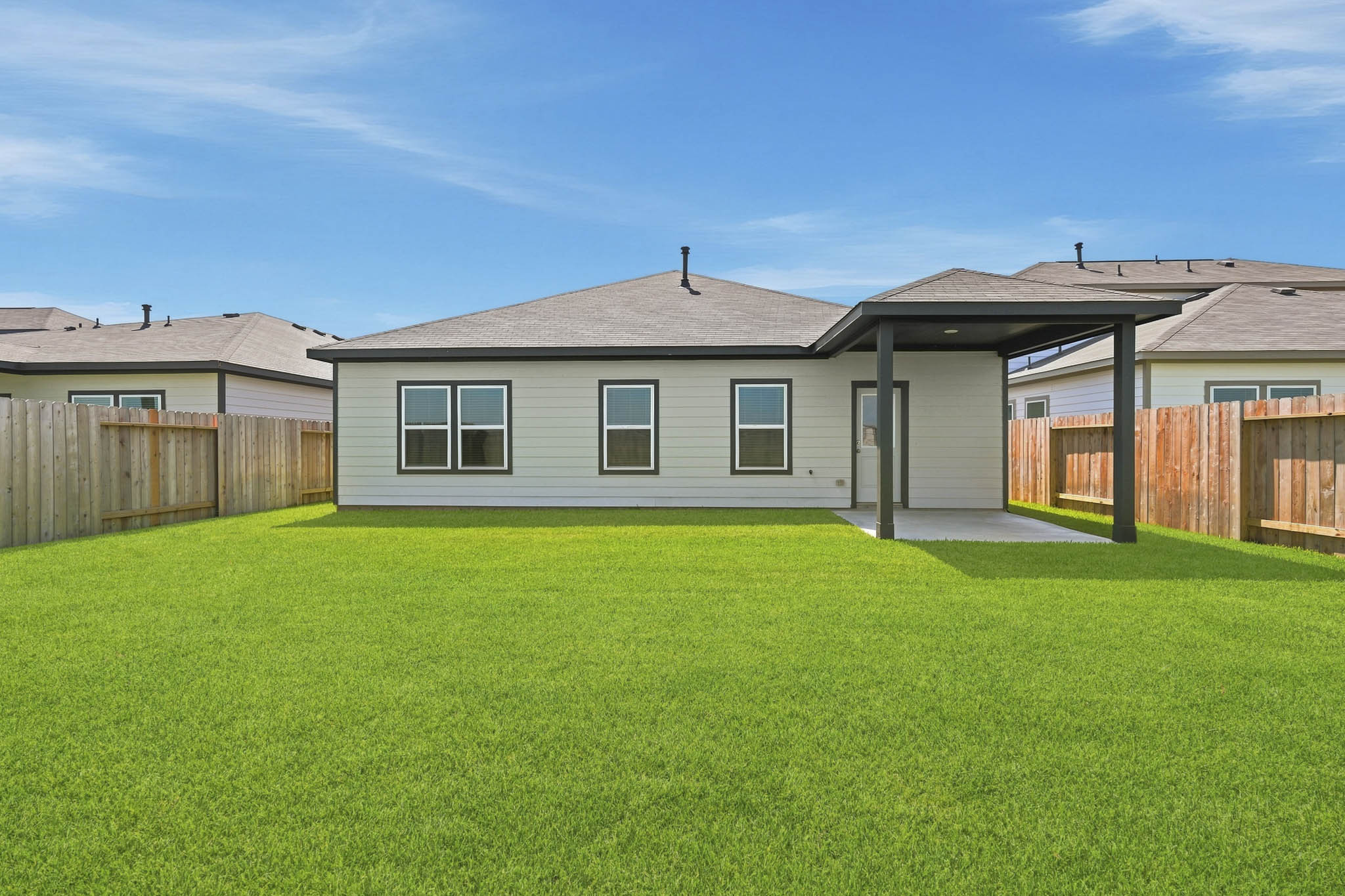 A house with a green lawn.