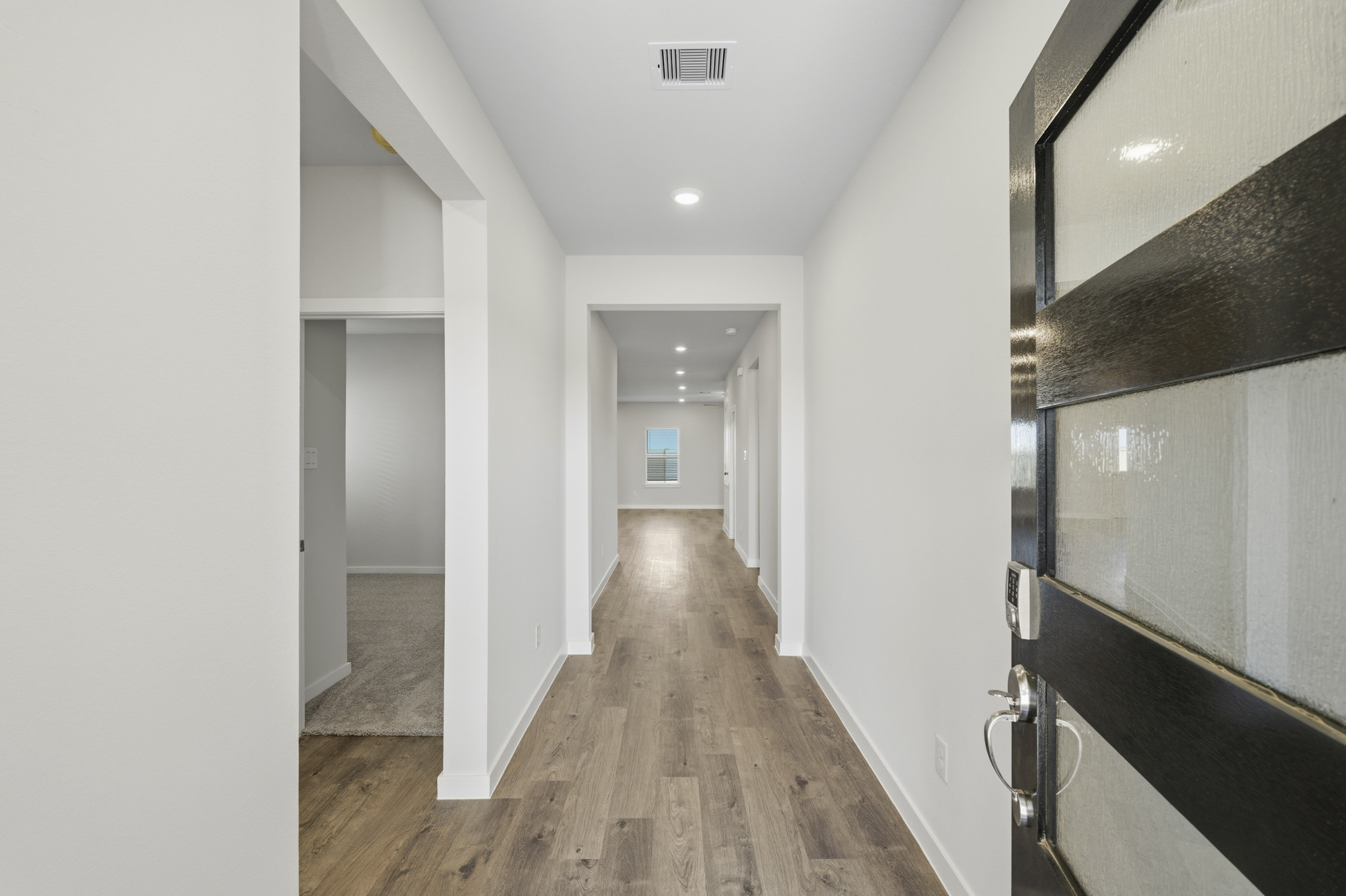 A hallway with white walls.