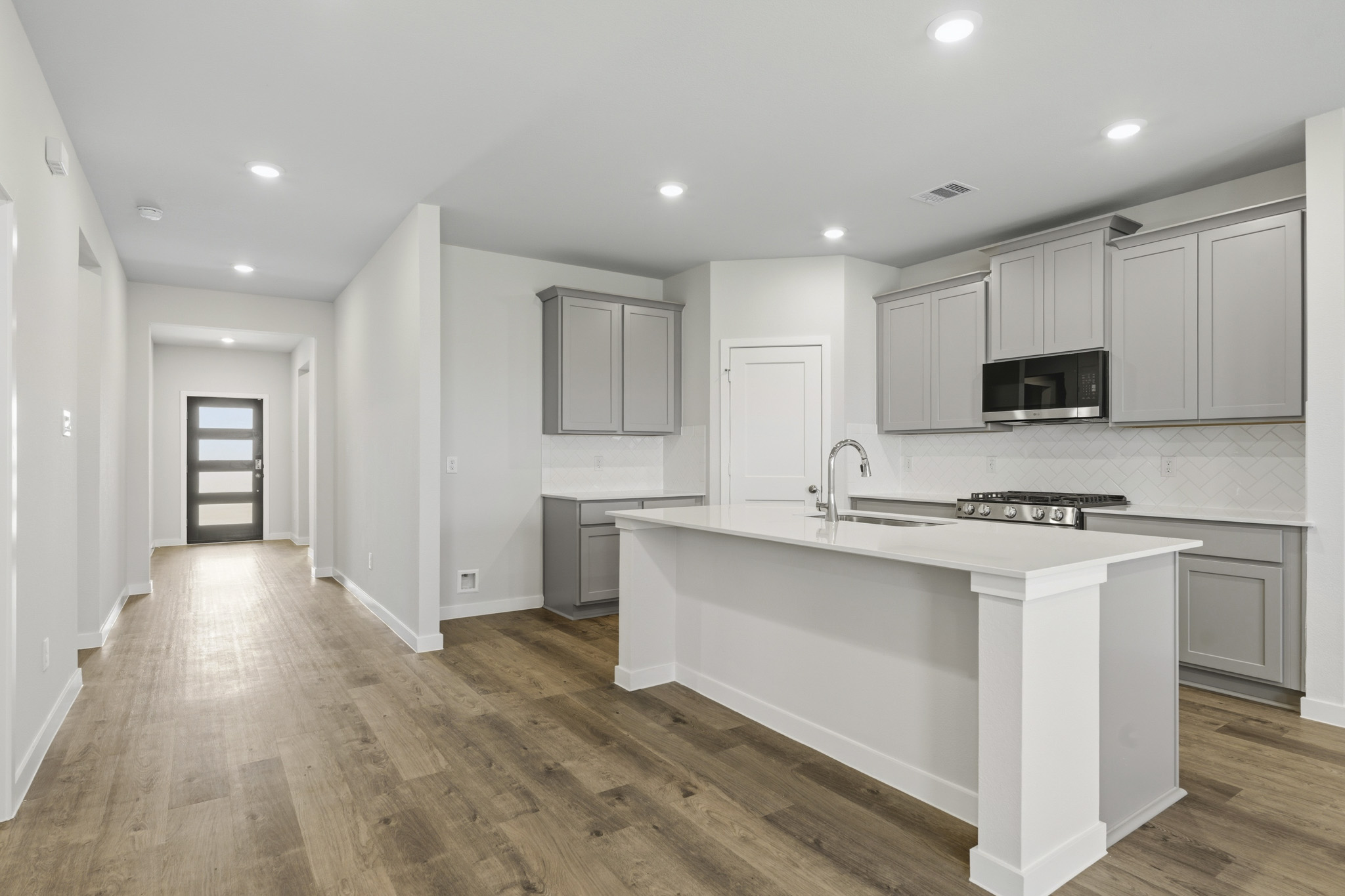 A kitchen with white cabinets.