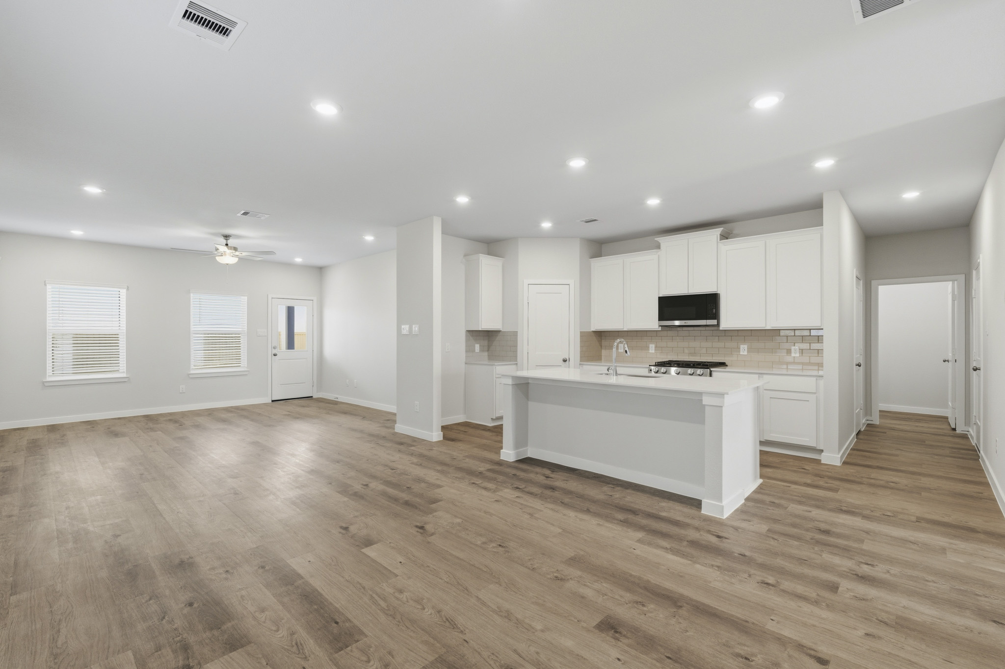 A large kitchen with white cabinets.