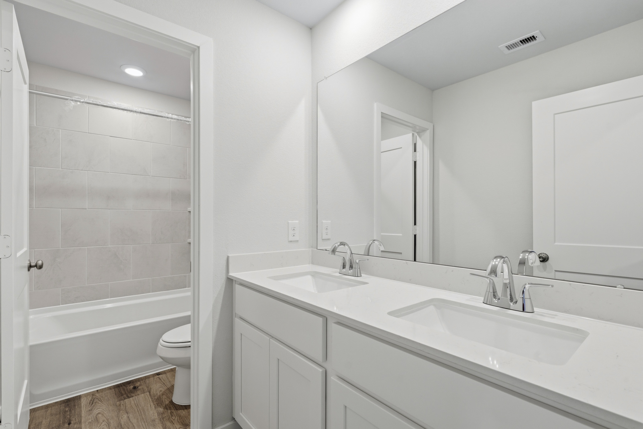 A bathroom with a tub sink and toilet.