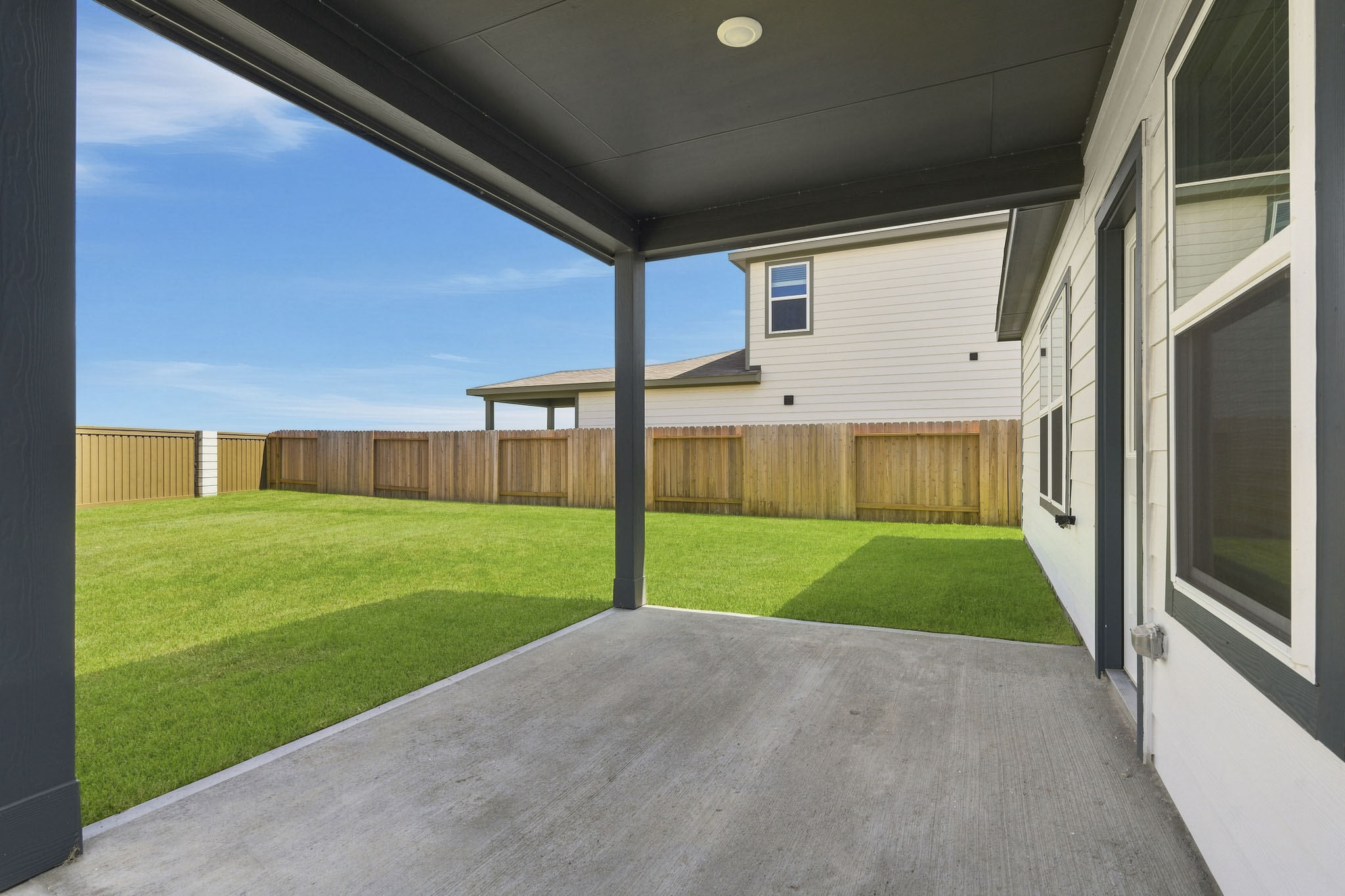 A backyard with a fence.