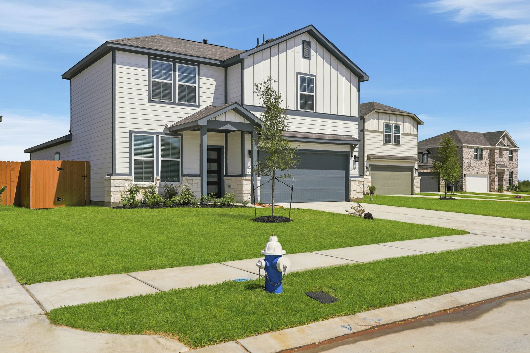 A fire hydrant in front of a house.