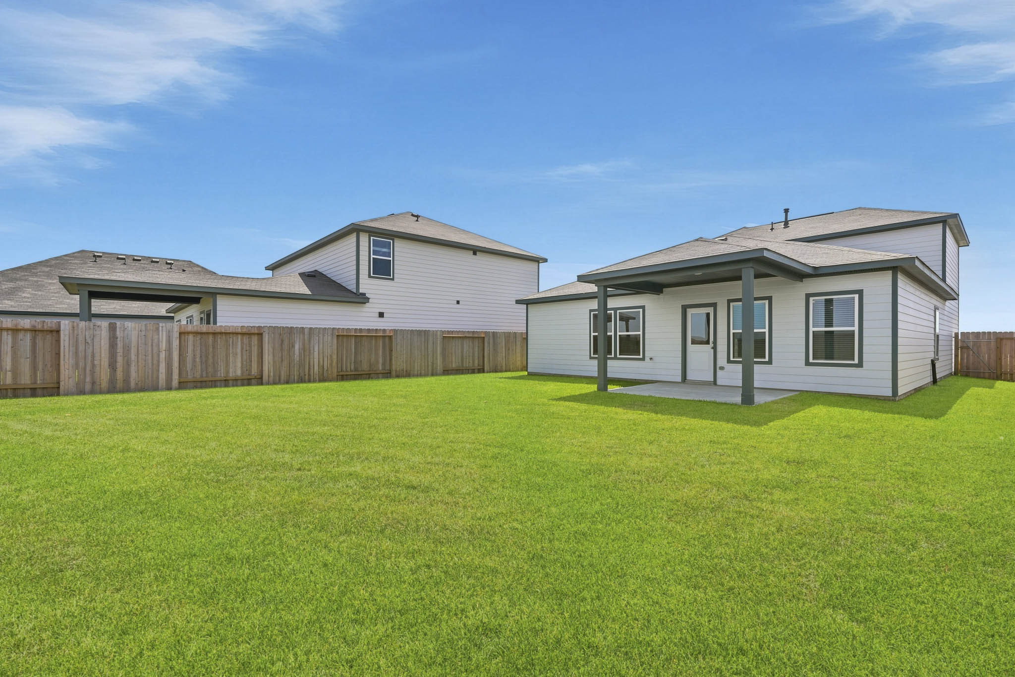 A house with a fence and grass.