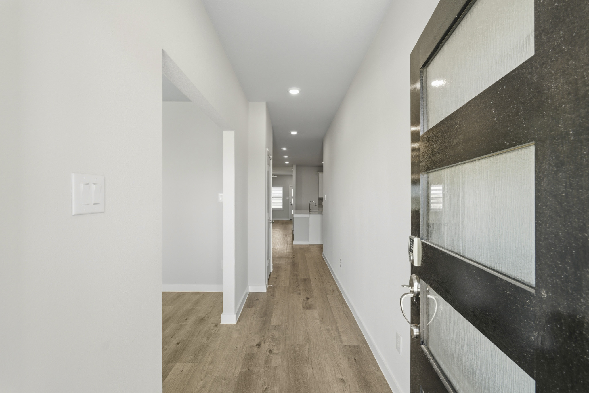 A hallway with white walls.