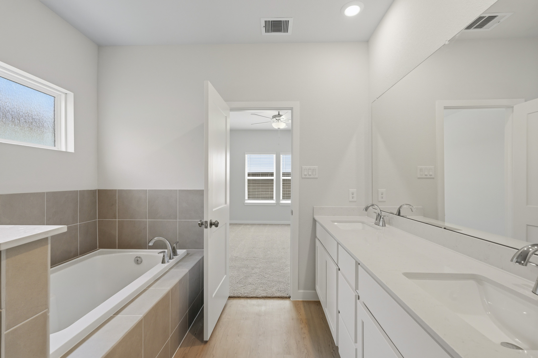 A bathroom with a tub and sink.