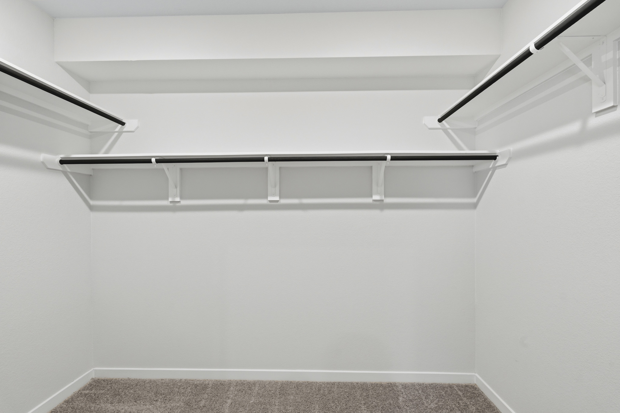 A white staircase with a black railing.