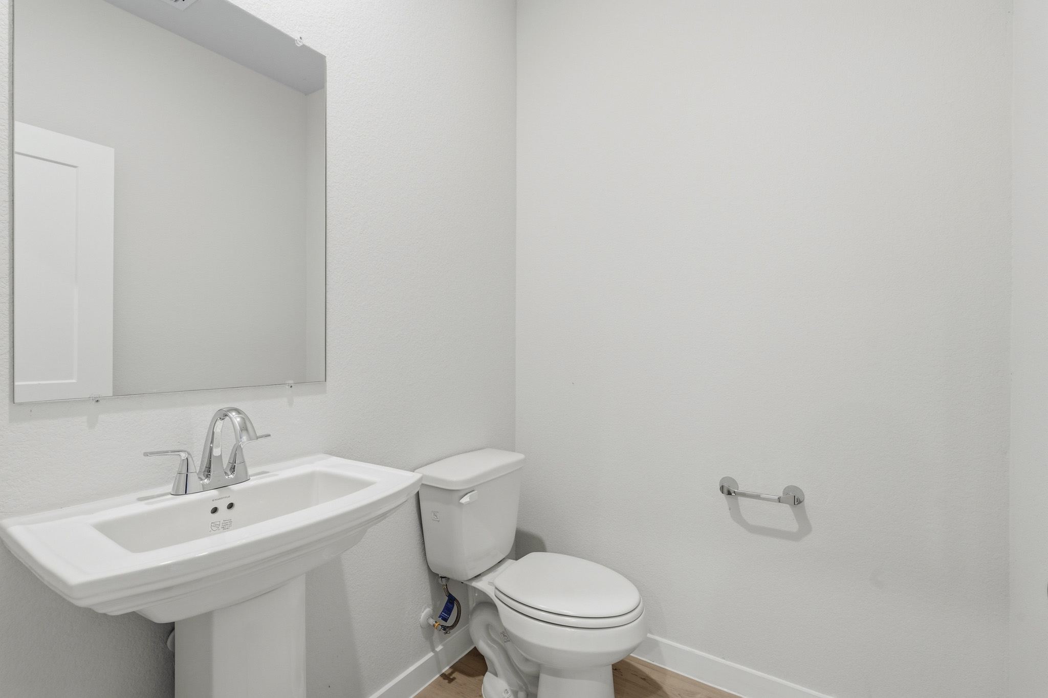 A bathroom with a toilet and sink.