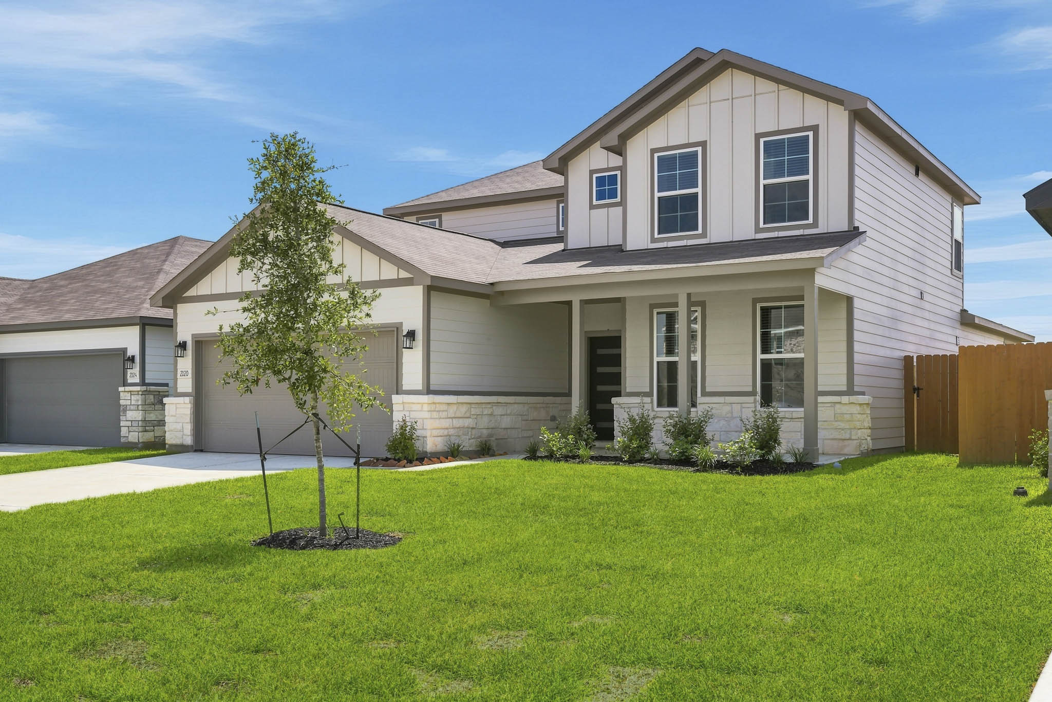 A house with a tree in the front yard.