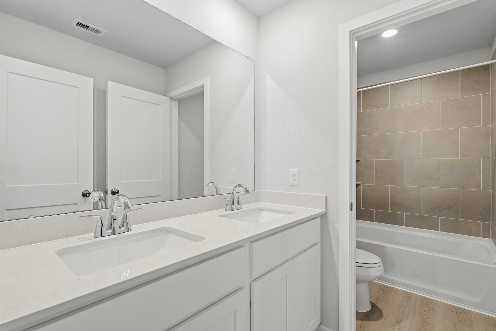 A bathroom with a tub sink and toilet.