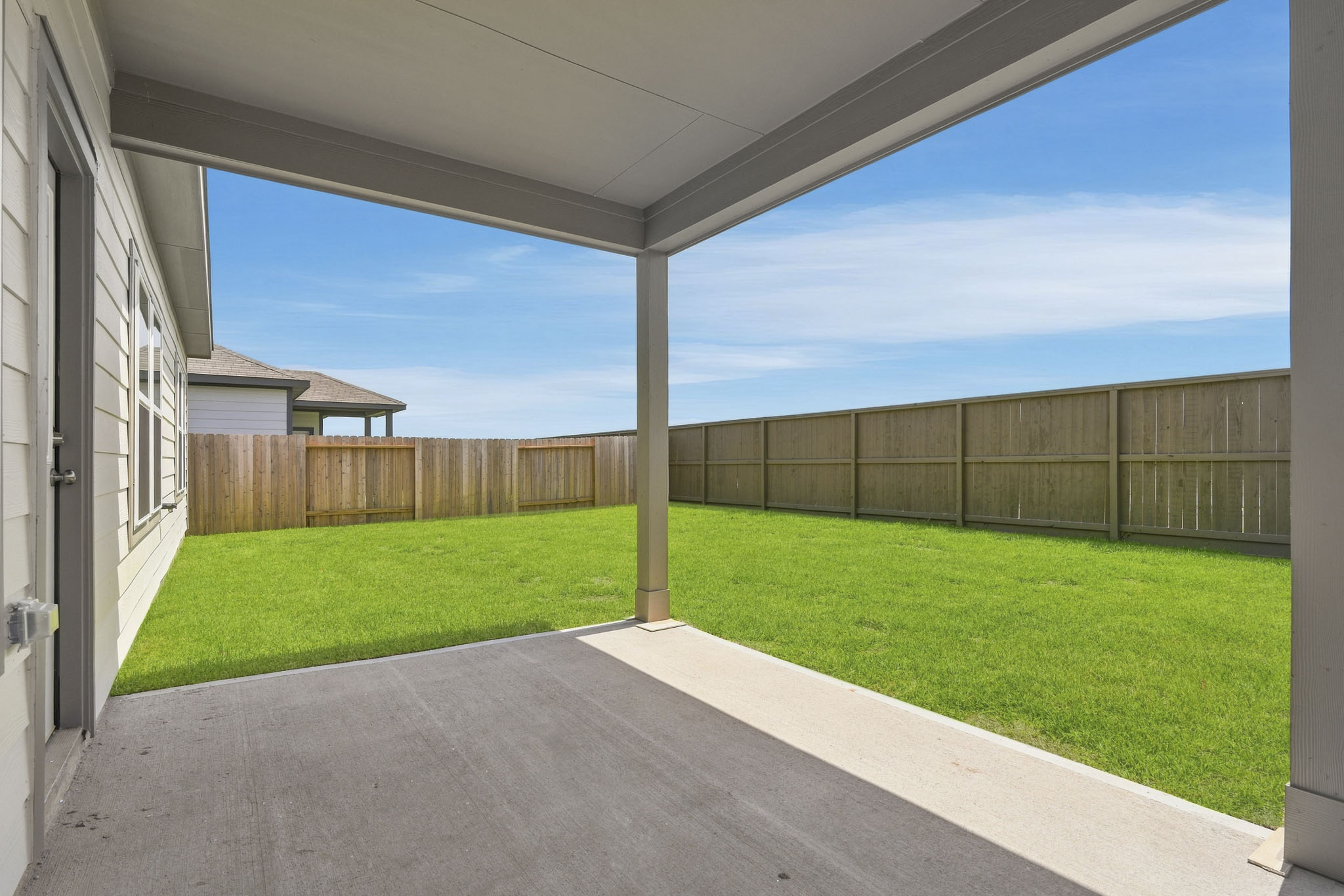 A building with a fence and grass.