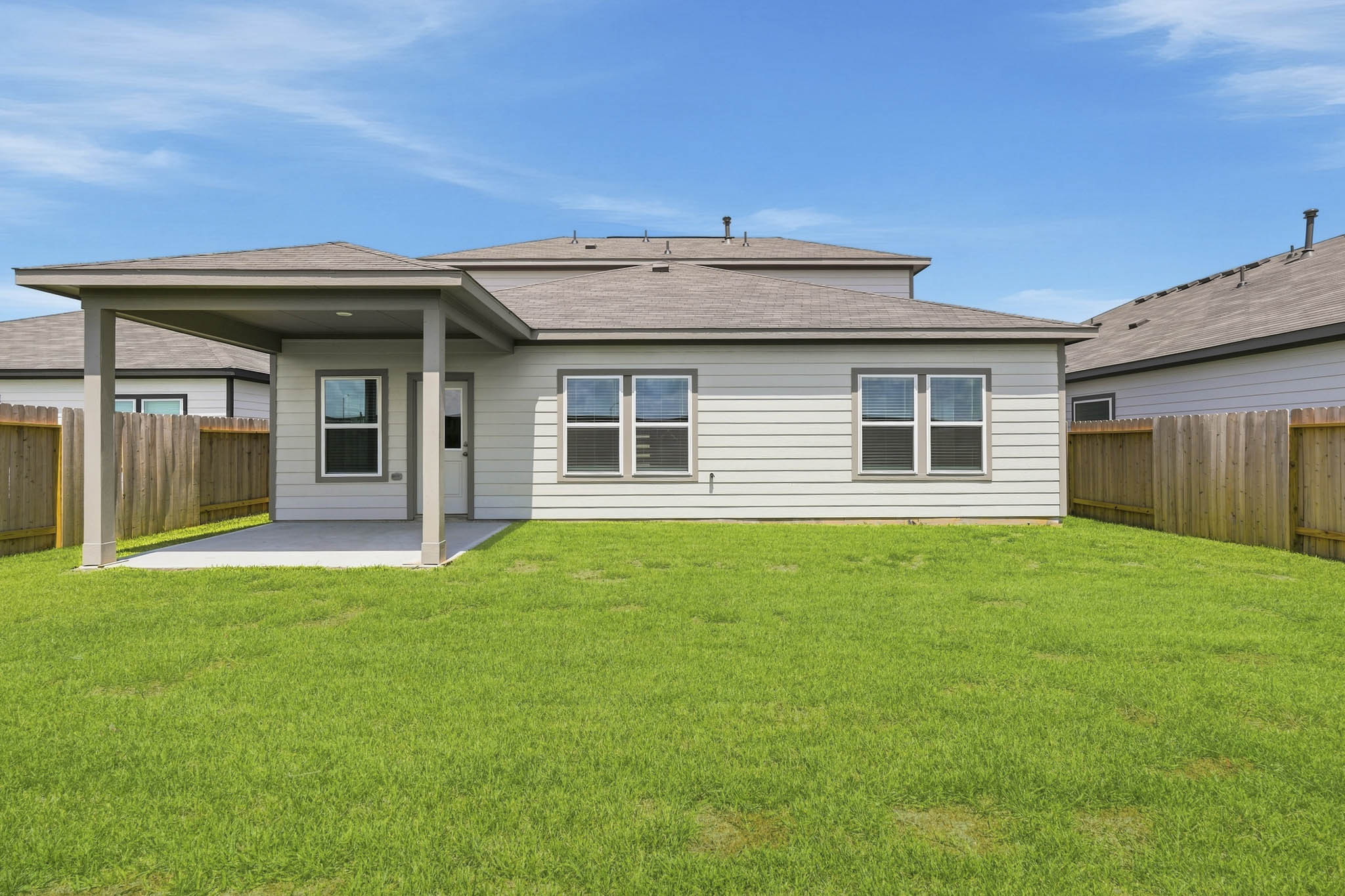 A house with a fence and grass.