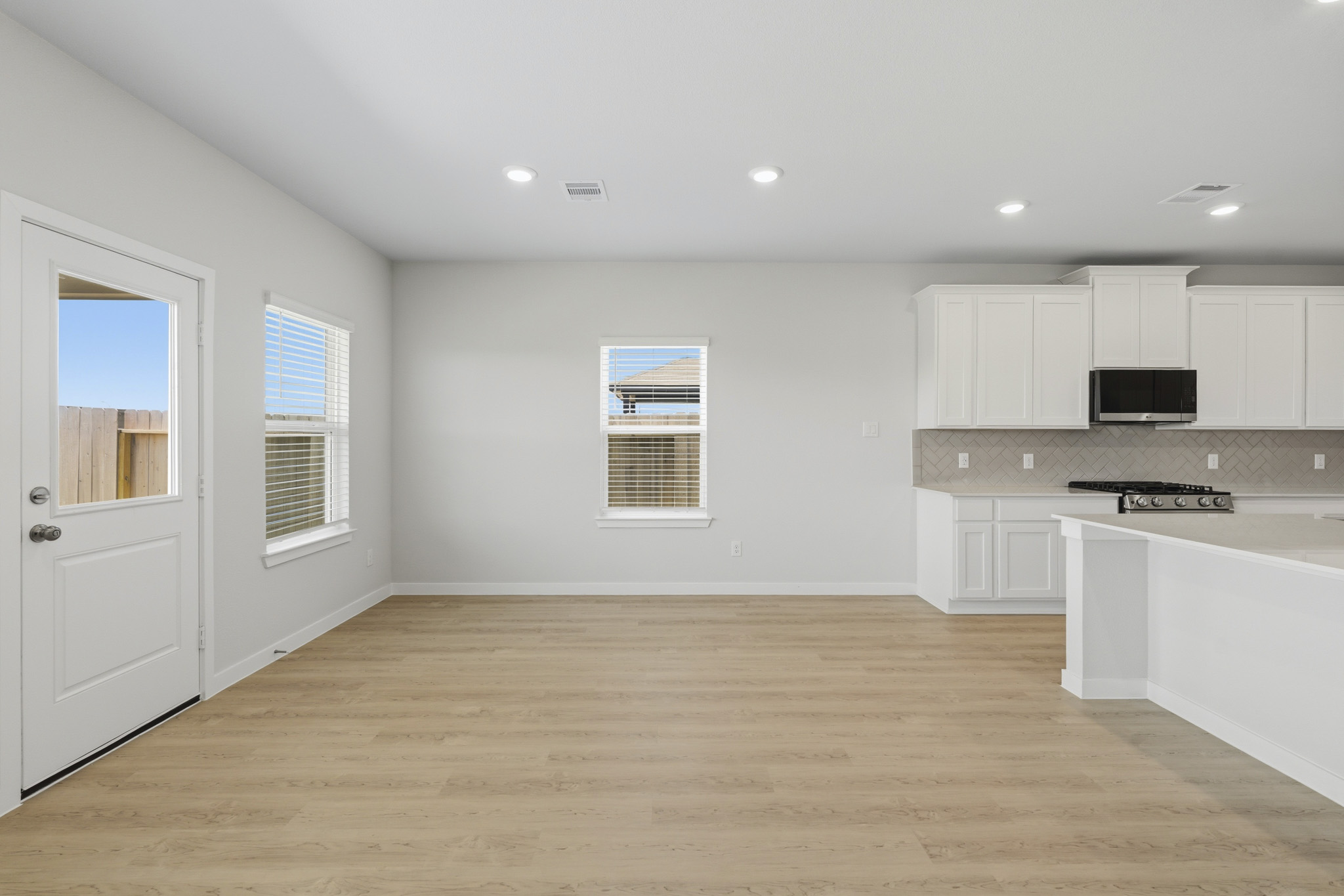 A kitchen with white cabinets.