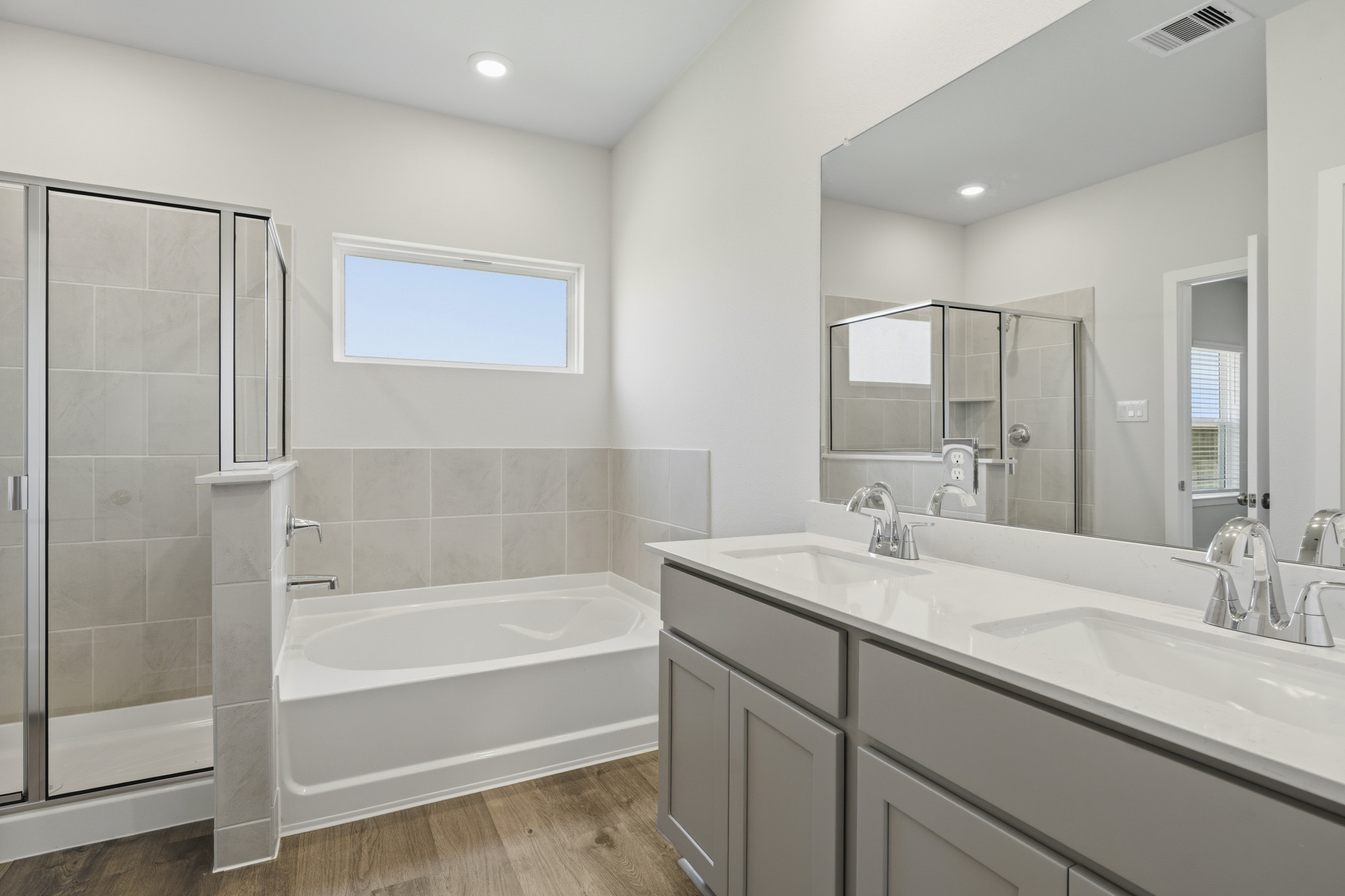 A bathroom with a tub sink and a shower.