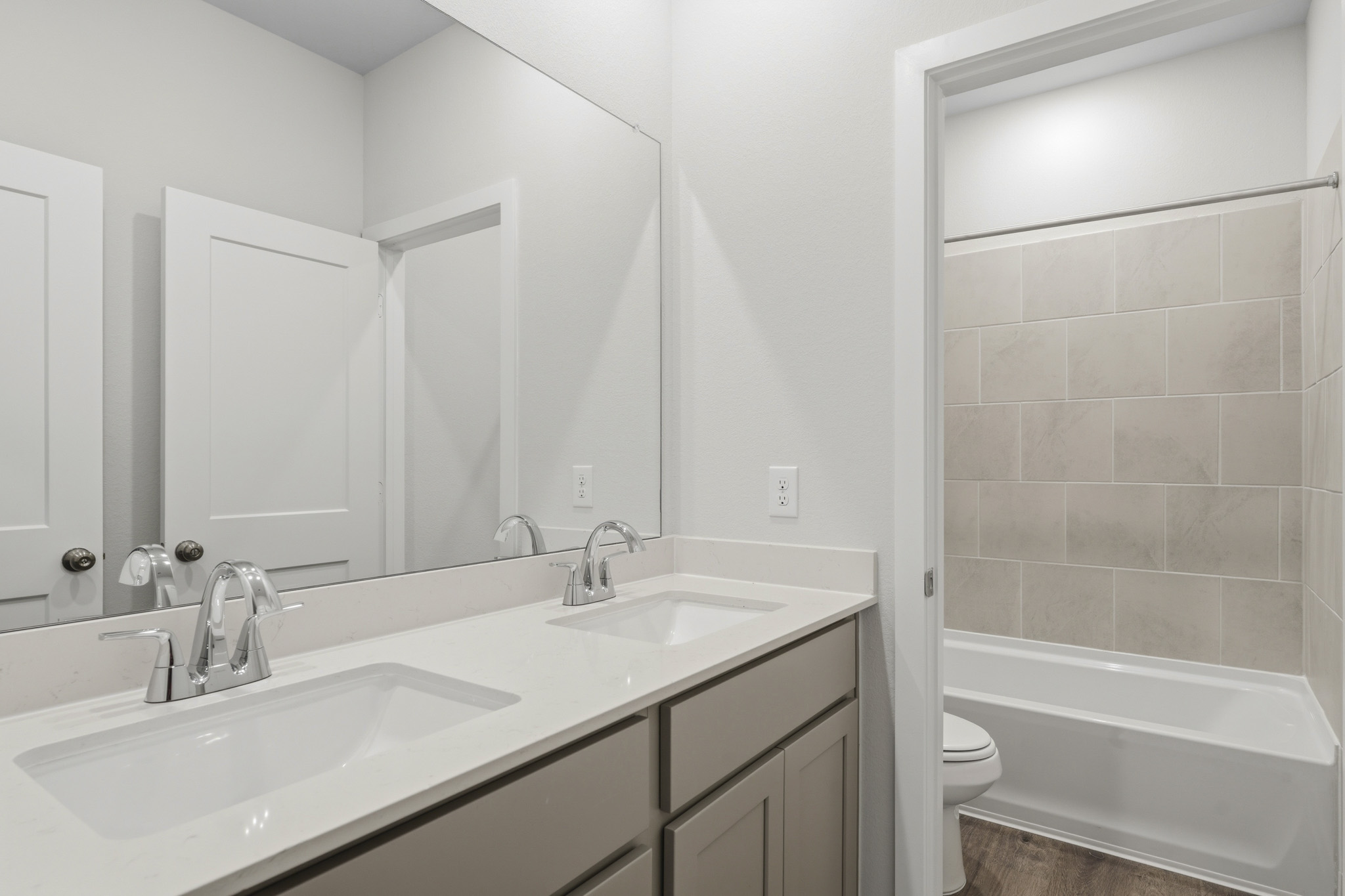 A bathroom with a tub sink and toilet.