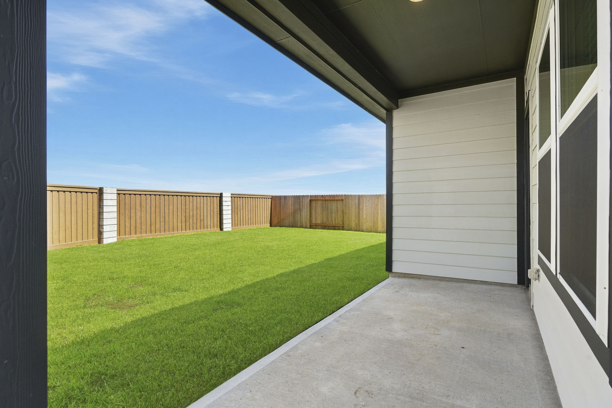 A backyard with a fence.