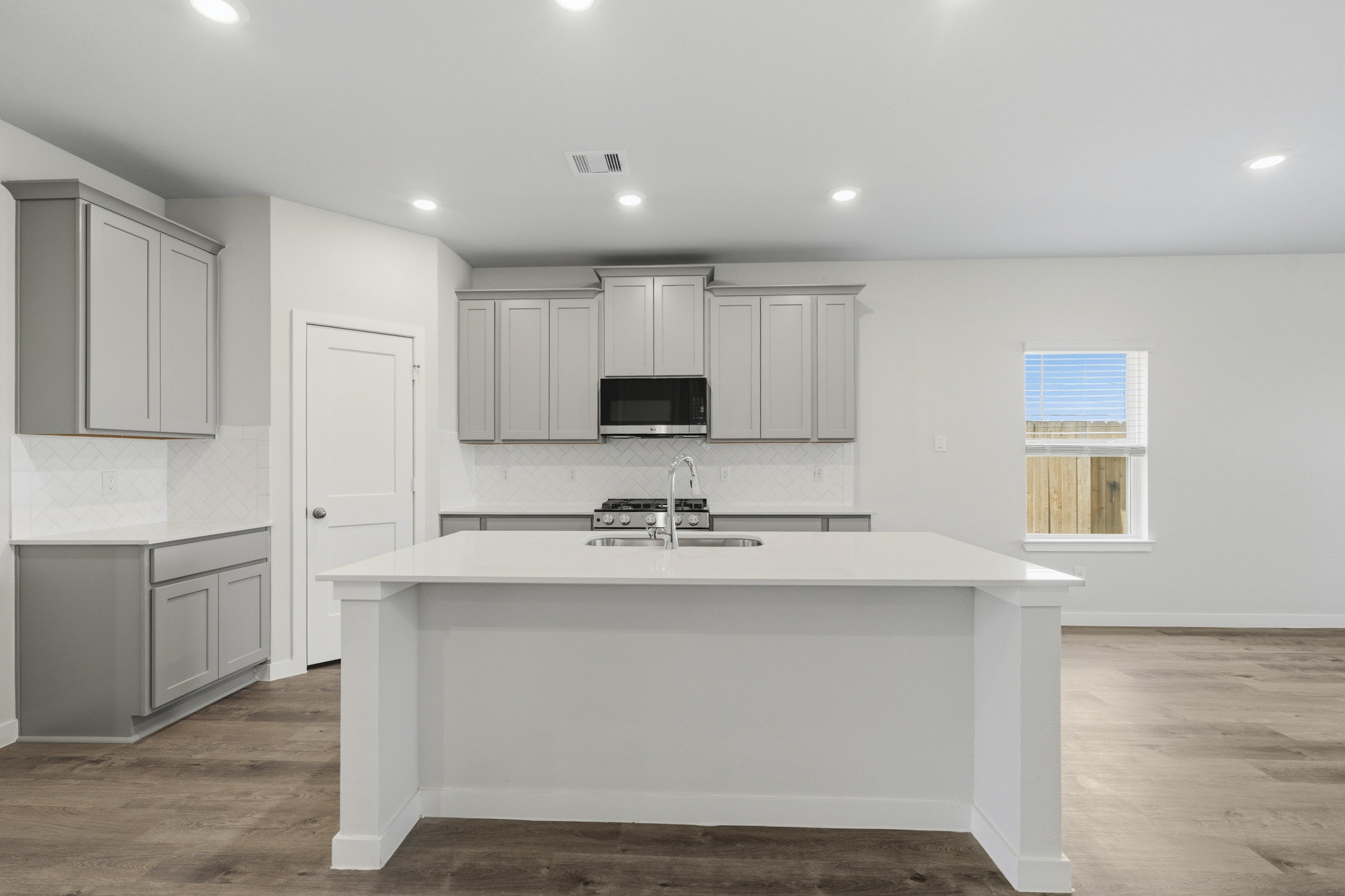 A kitchen with white cabinets.