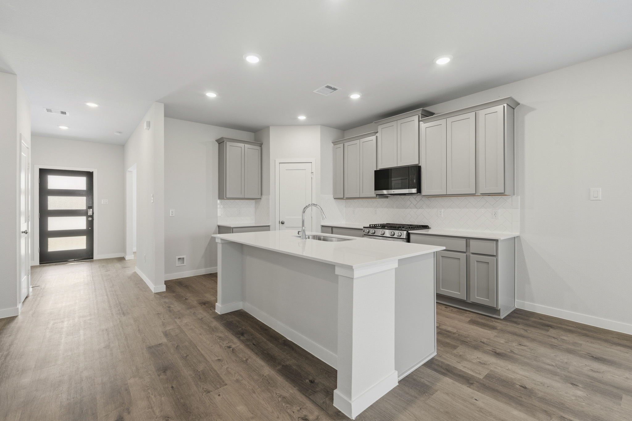 A kitchen with white cabinets.