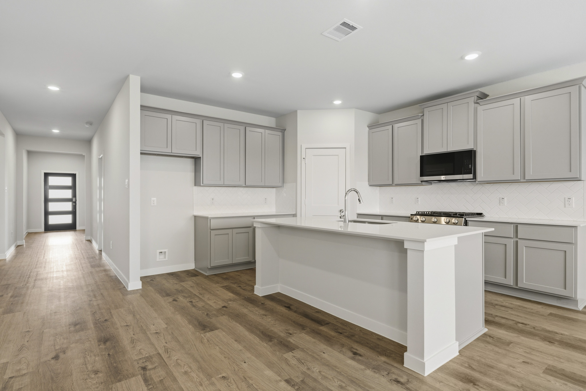 A kitchen with white cabinets.