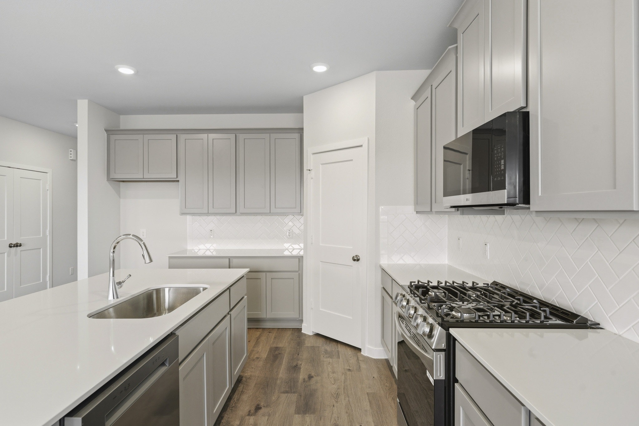 A kitchen with white cabinets.