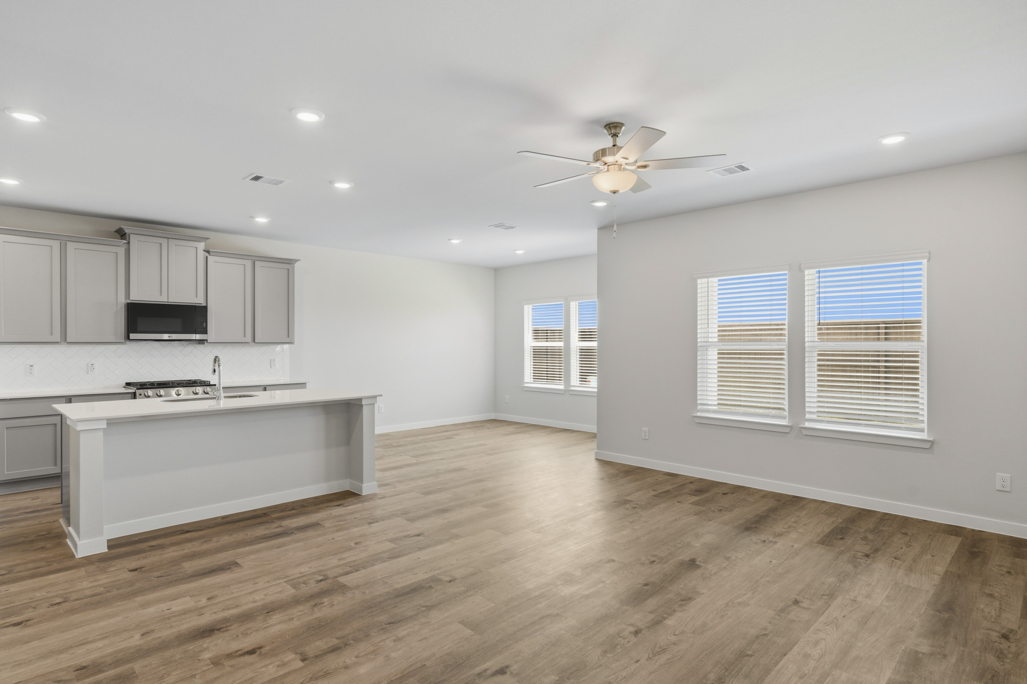 A kitchen with white cabinets.