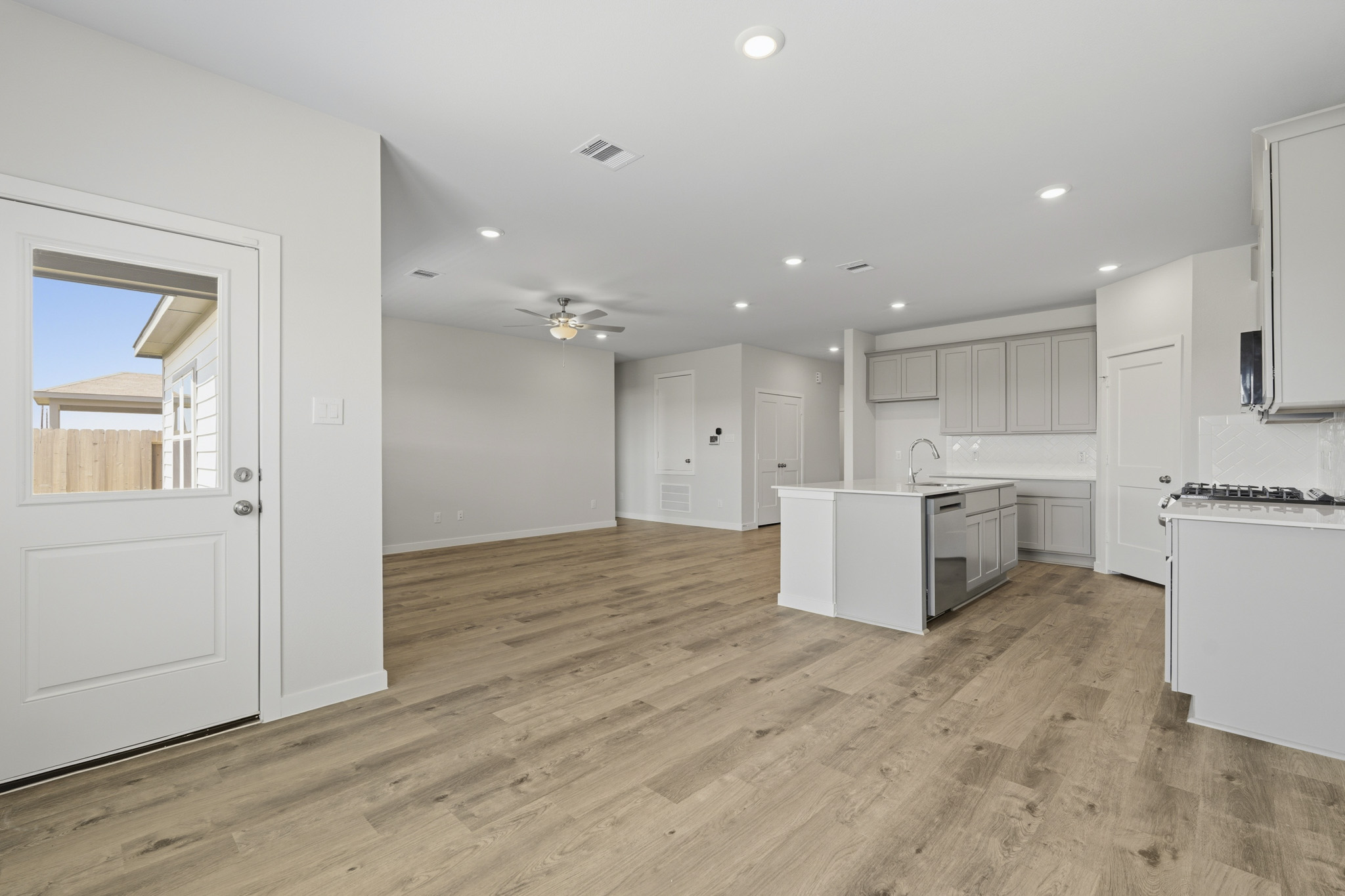 A kitchen with white cabinets.