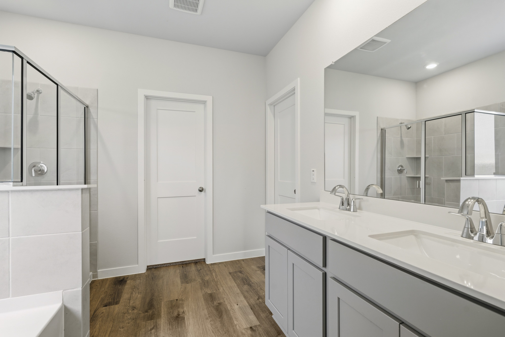 A bathroom with white cabinets.