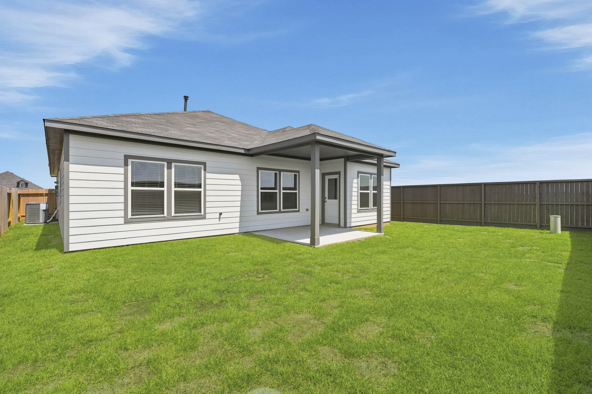 A house with a fence and grass.