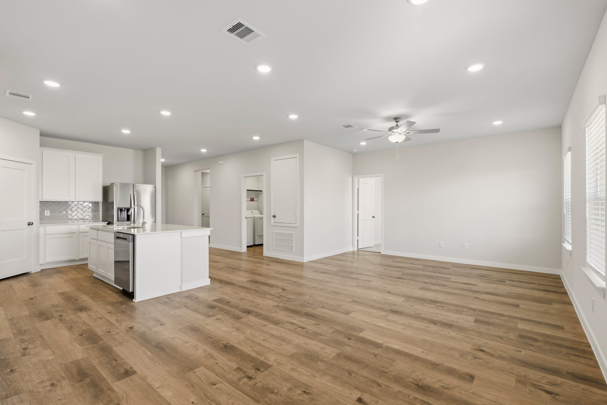A large kitchen with white cabinets.