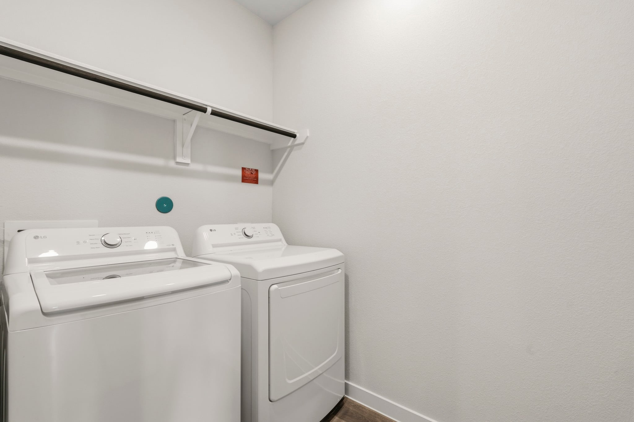 A washing machine and dryer in a room.