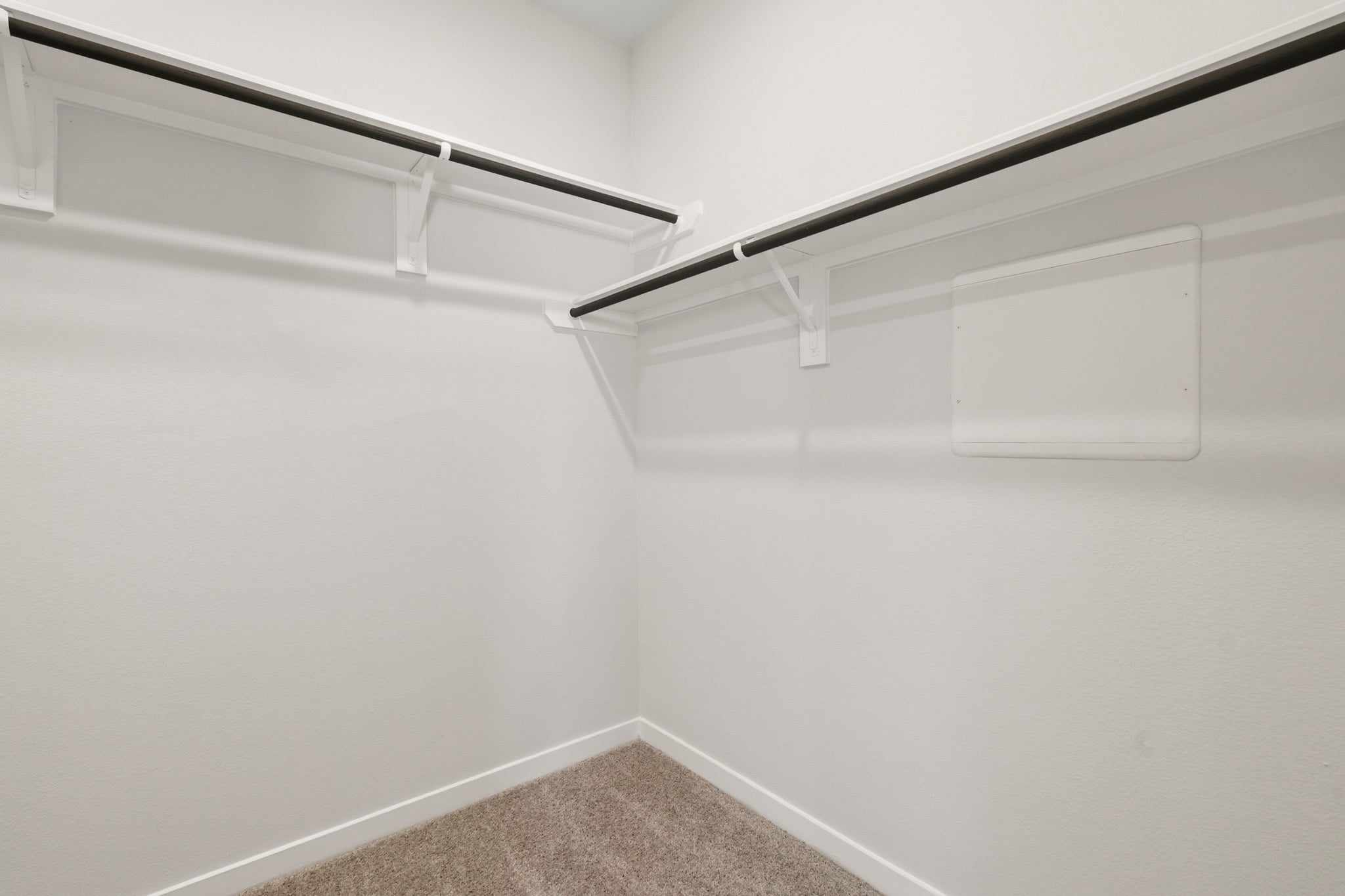A white wall with a metal railing.