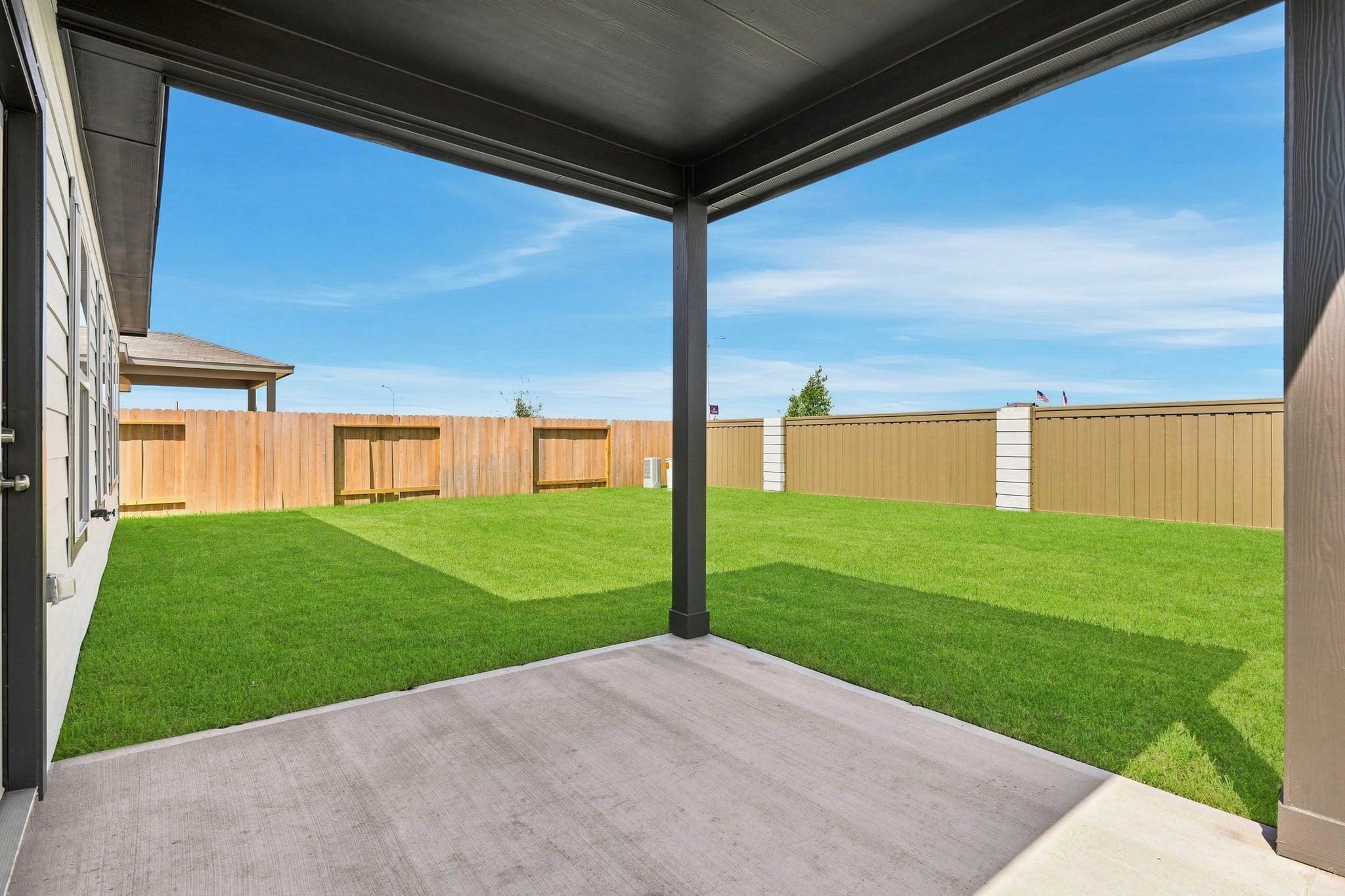 A backyard with a fence.