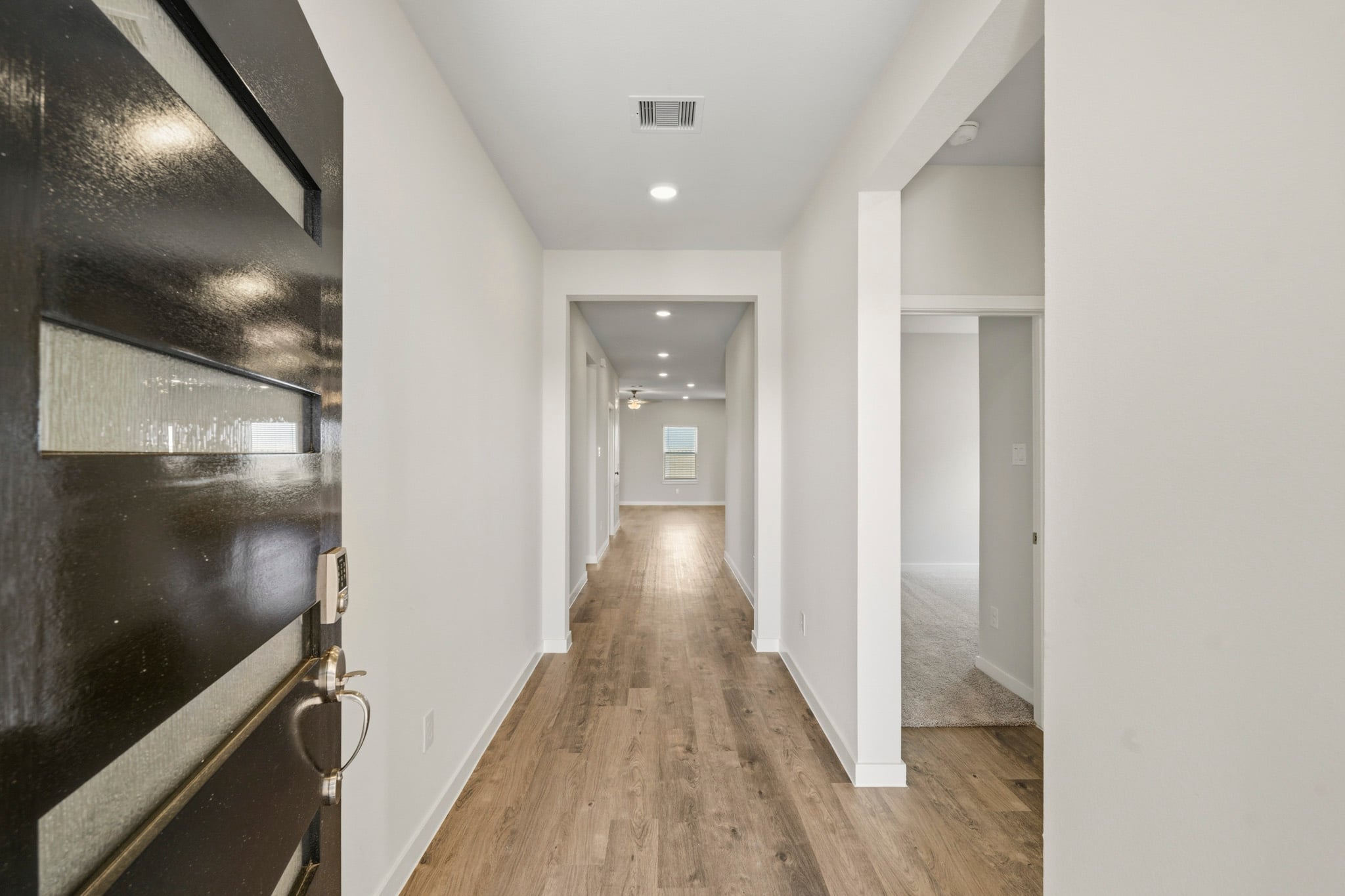 A hallway with white walls.