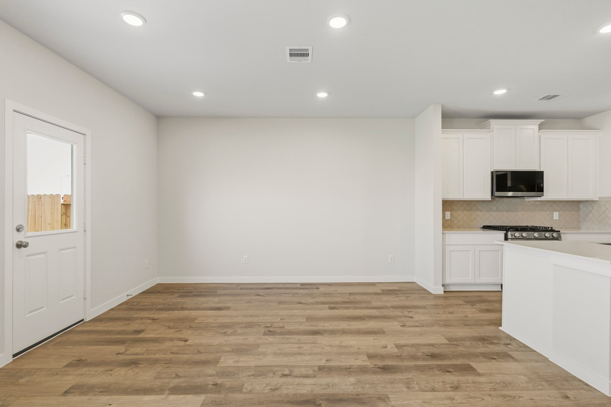 A kitchen with white cabinets.