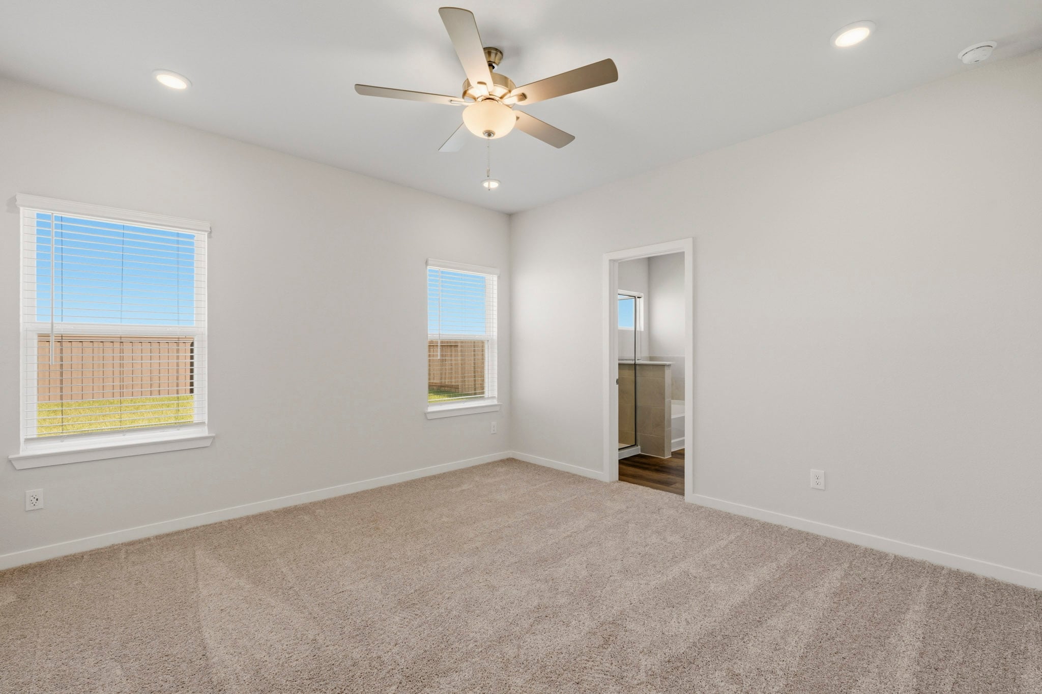 A room with a ceiling fan and a window.