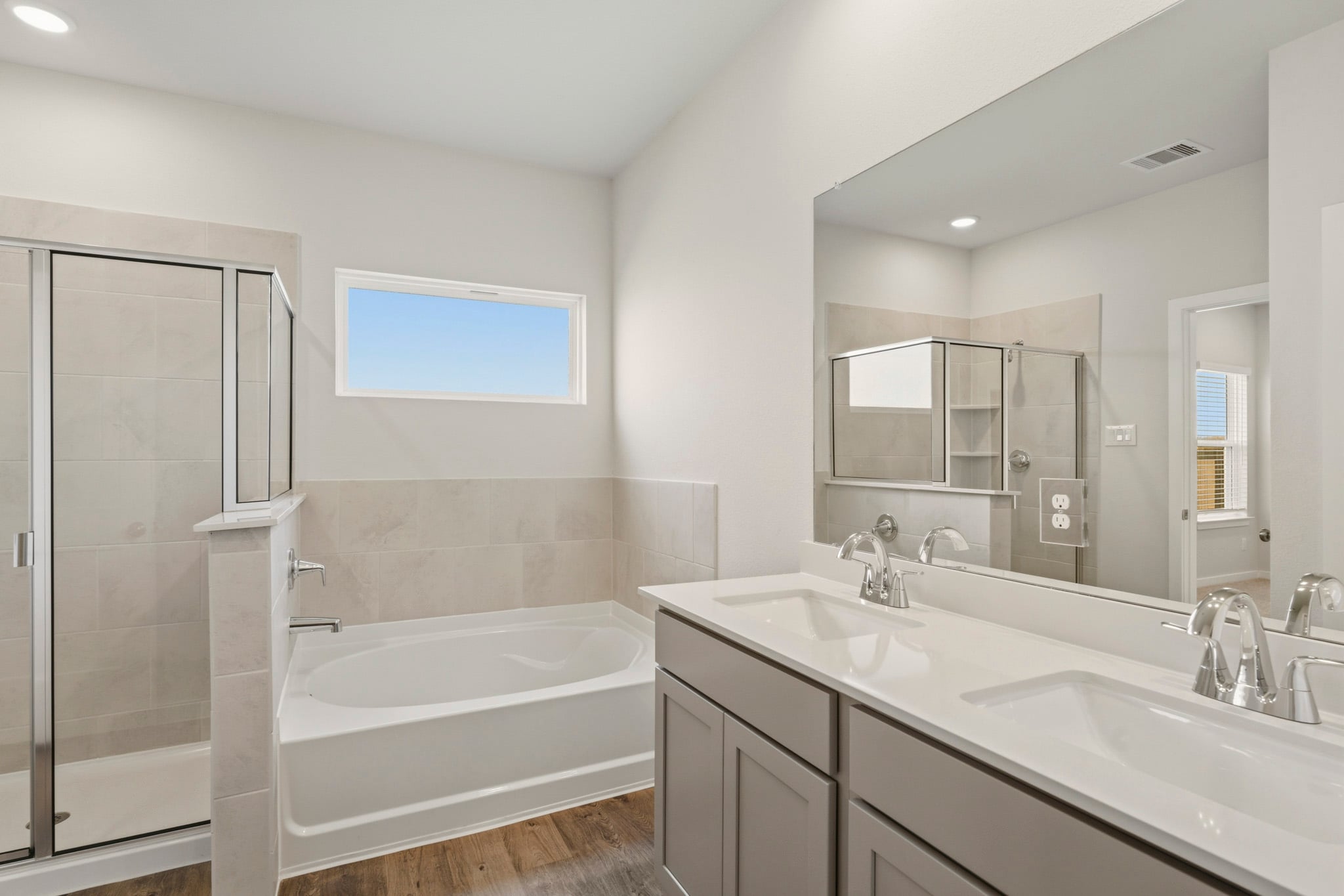 A bathroom with a tub sink and a shower.