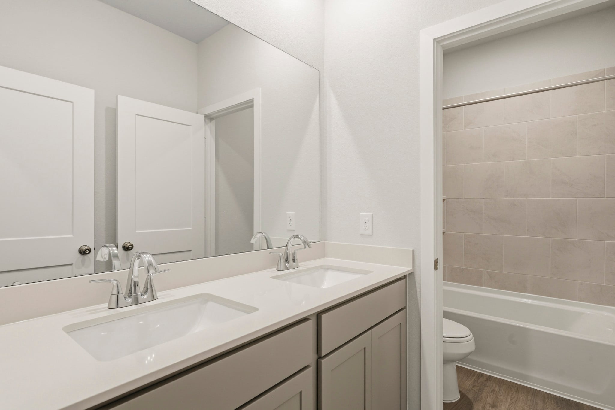 A bathroom with a tub sink and toilet.