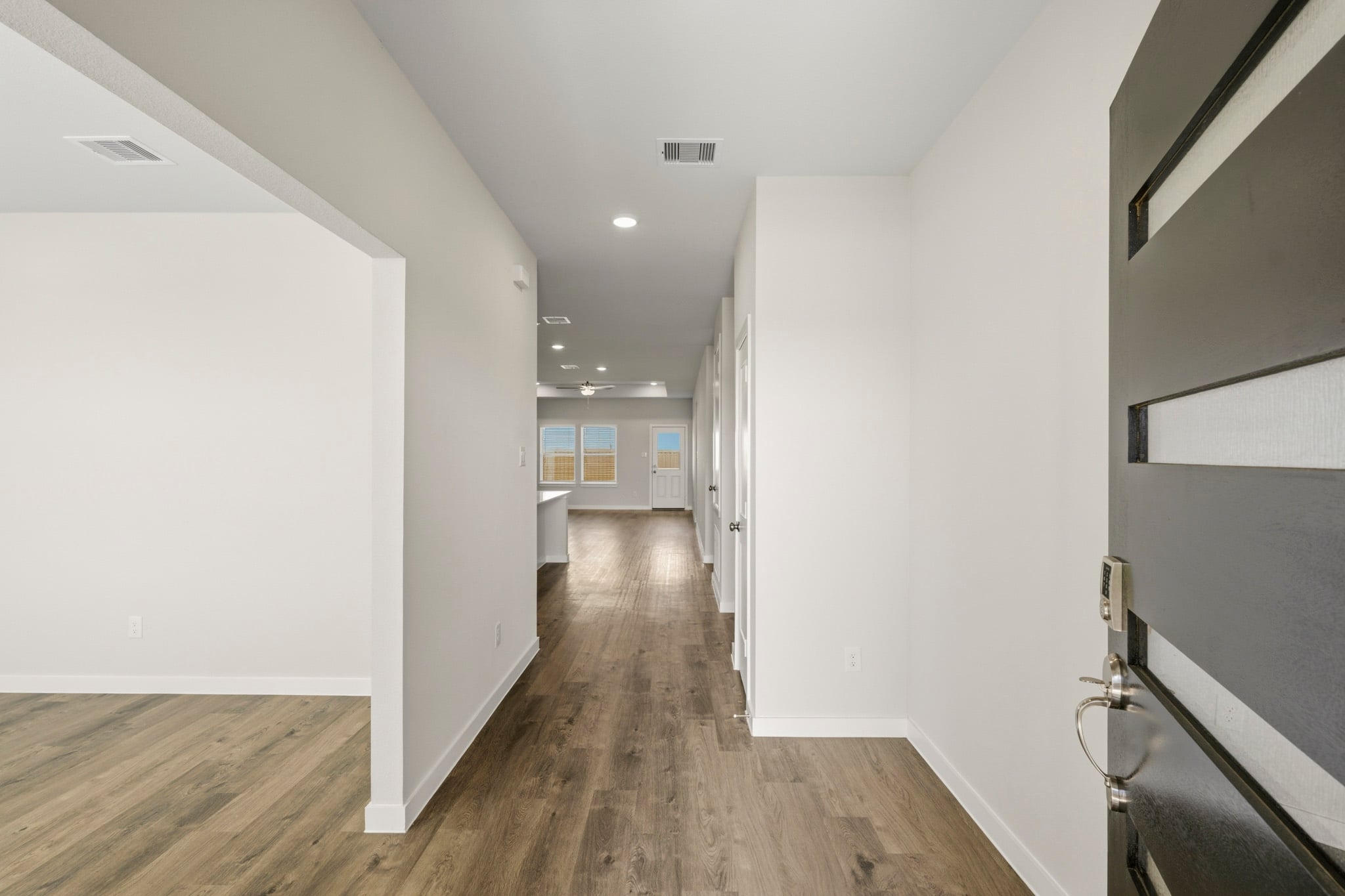 A hallway with white walls.