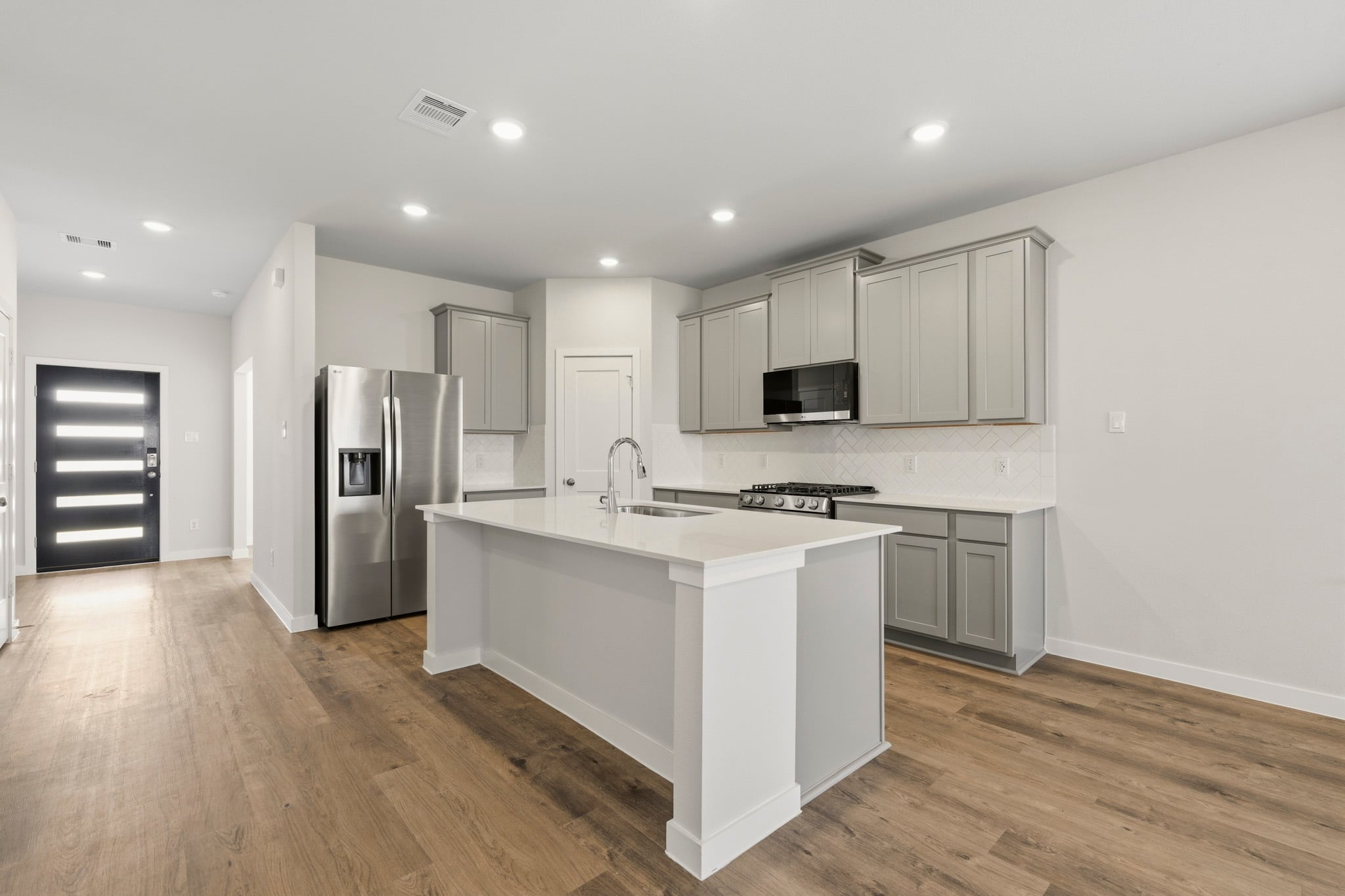 A kitchen with white cabinets.