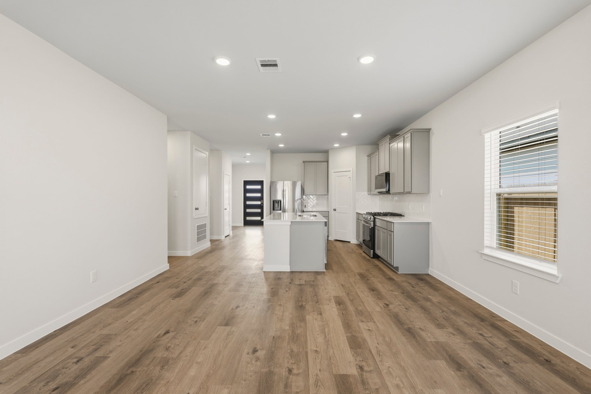 A kitchen with white walls.