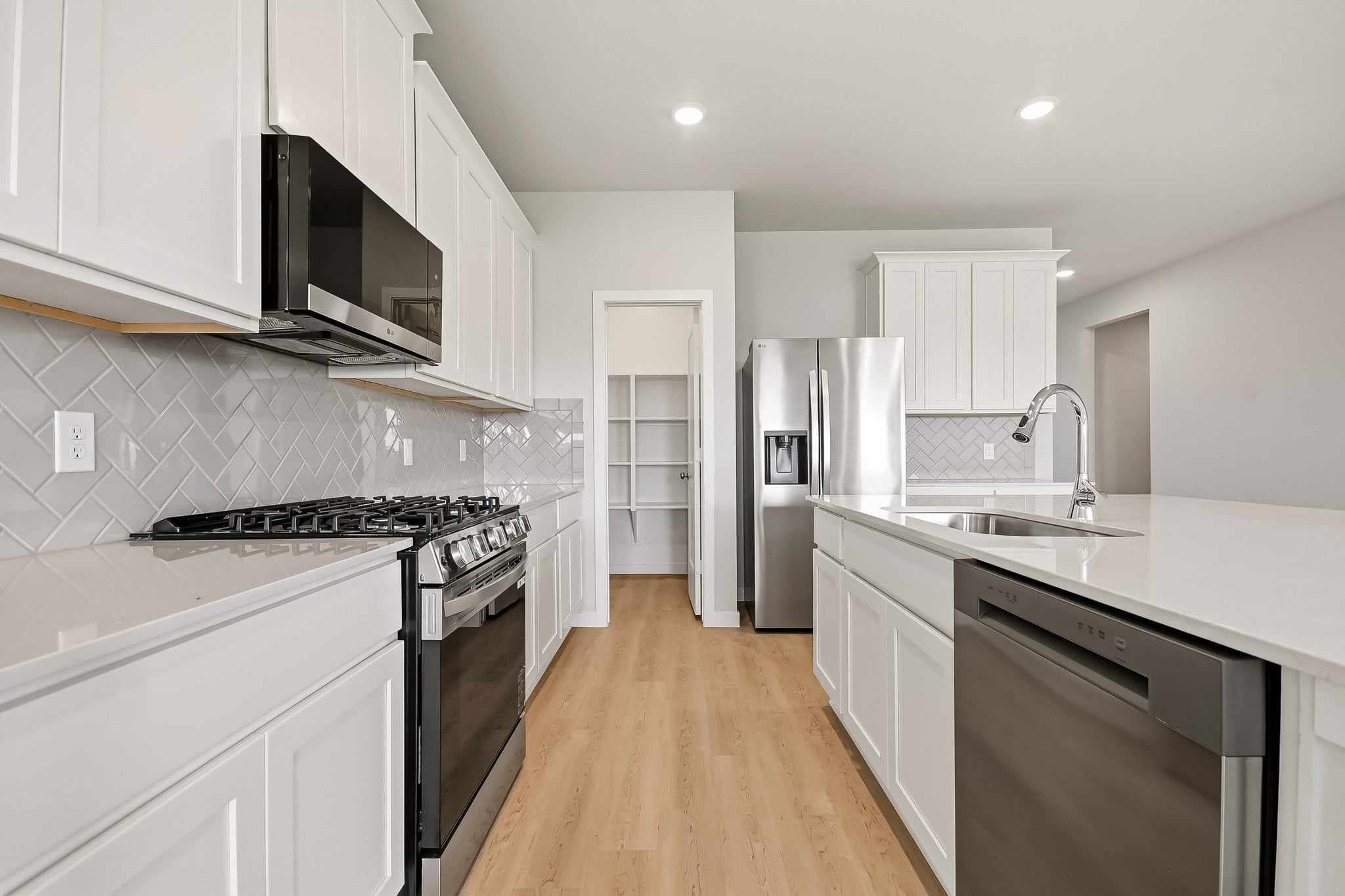 A kitchen with white cabinets.