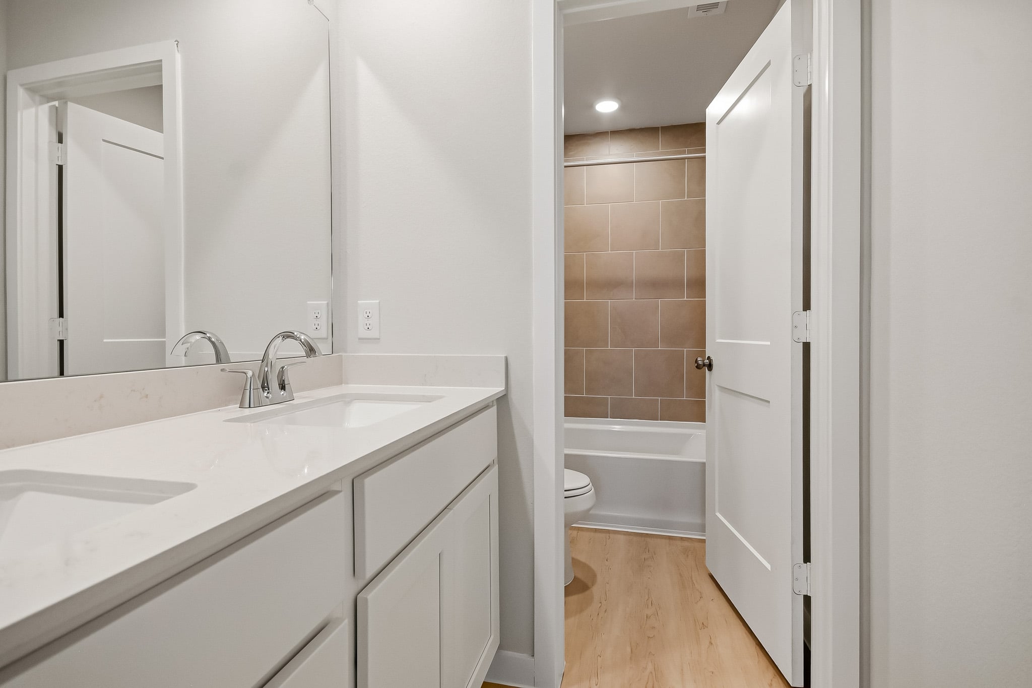 A bathroom with a tub sink and toilet.